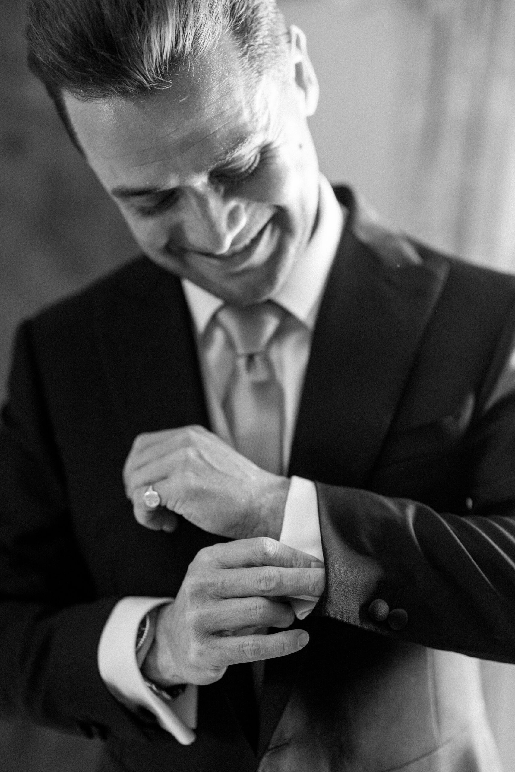 stylish groom getting ready for his timeless country garden wedding