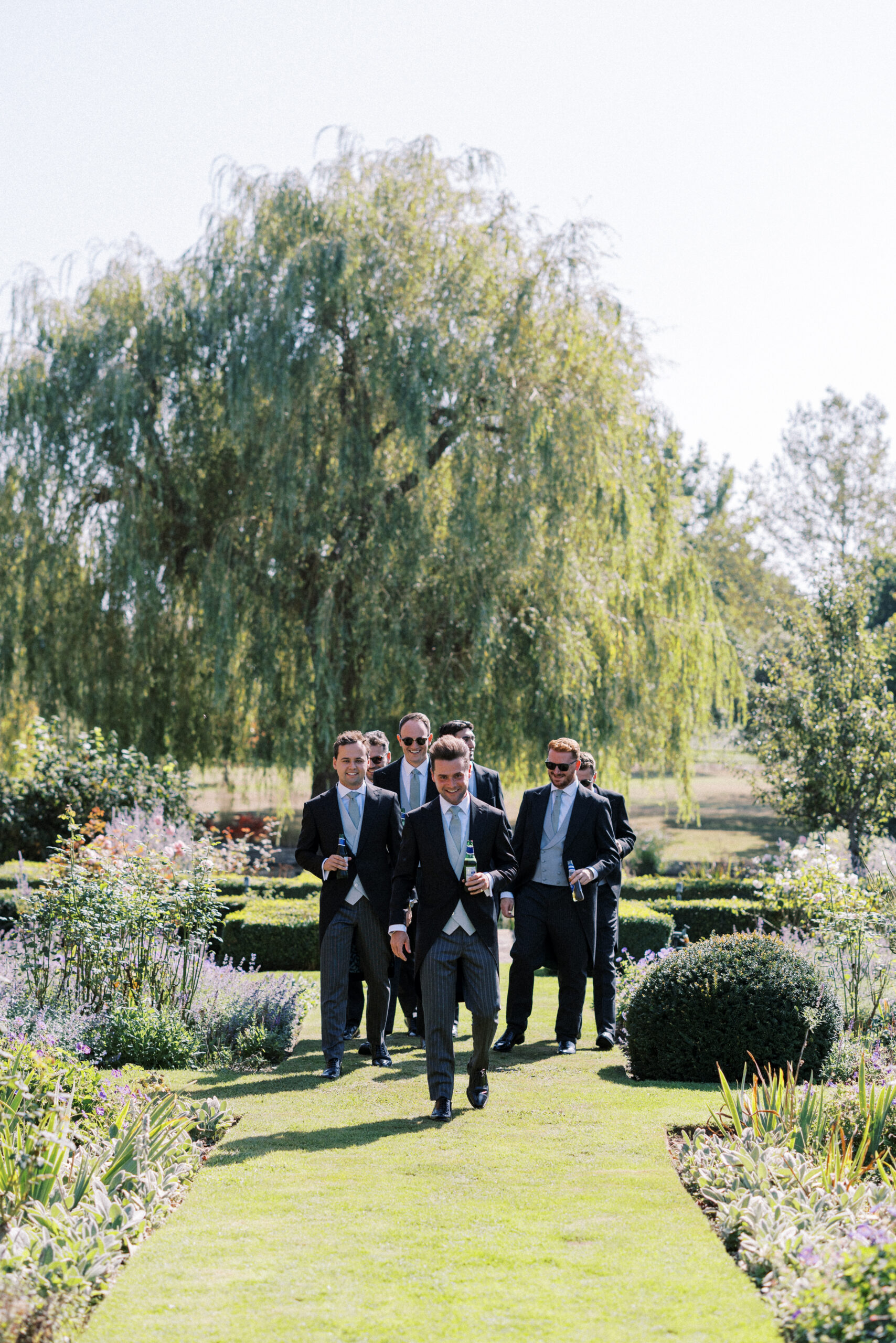 stylish groom getting ready for his timeless country garden wedding