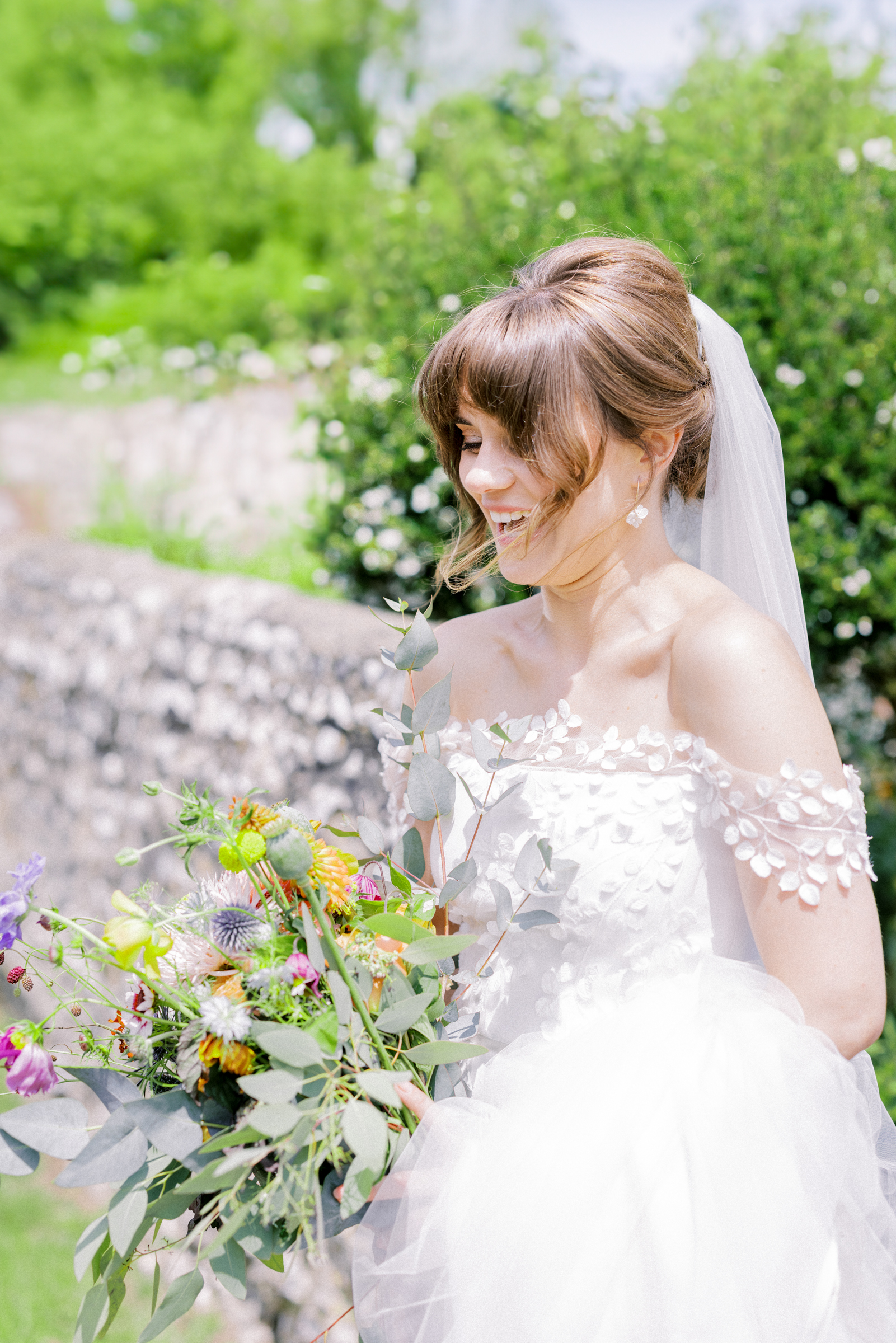 Bride and her homemade flowers at her South Stoke Barn Wedding