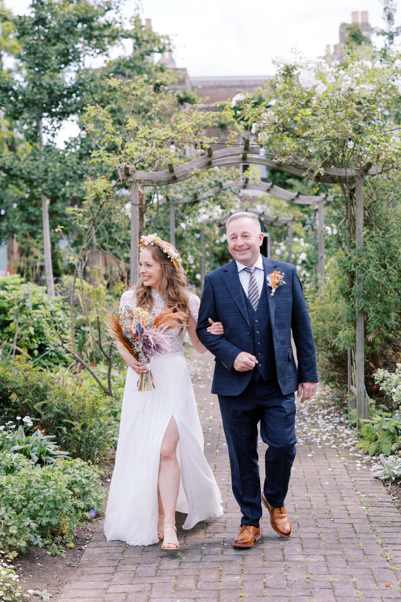 Bride walks down the aisle on her wedding day at Morden Park House