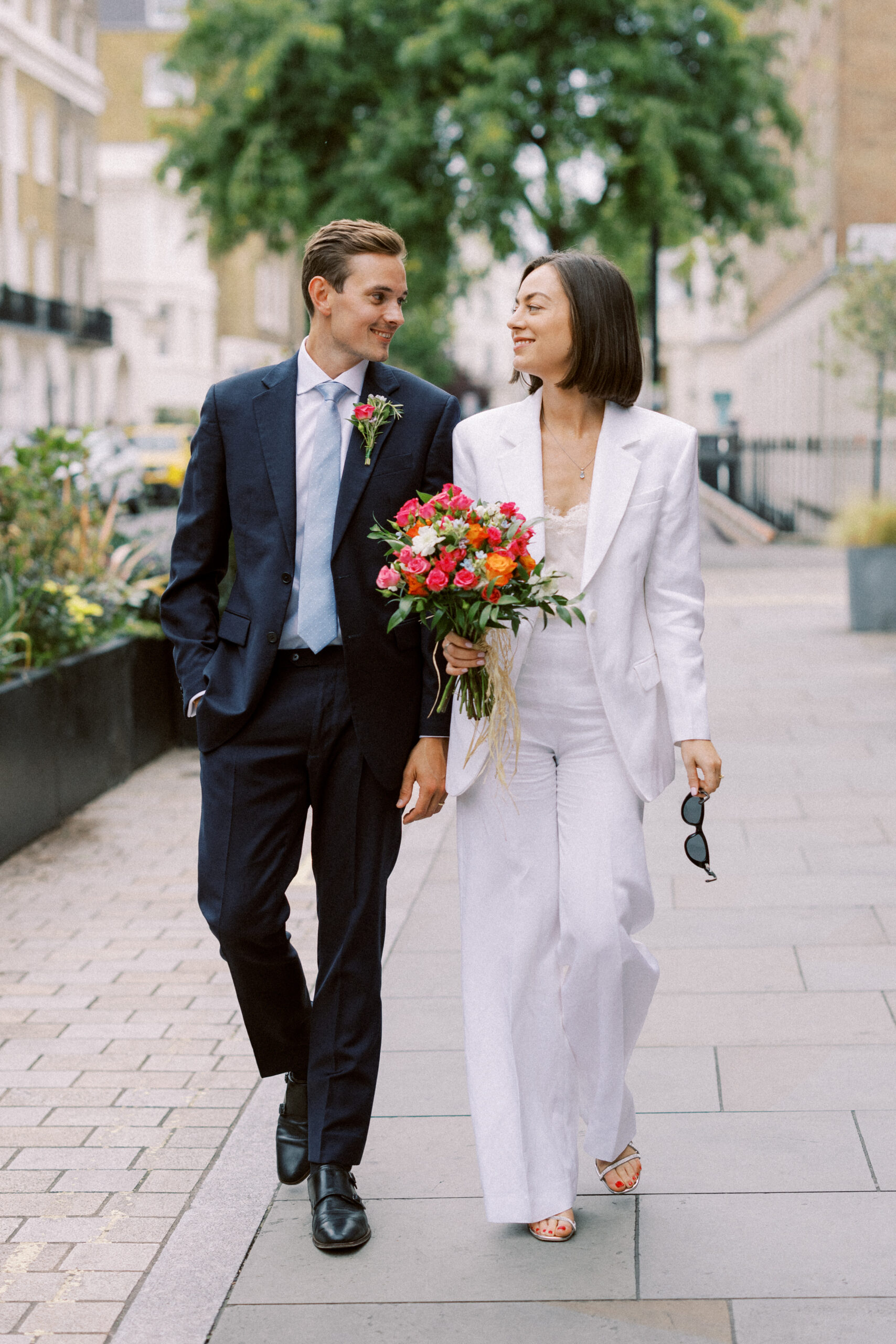 Wedding day couple walk down Belgravia after their Chelsea Old Town Hall Wedding