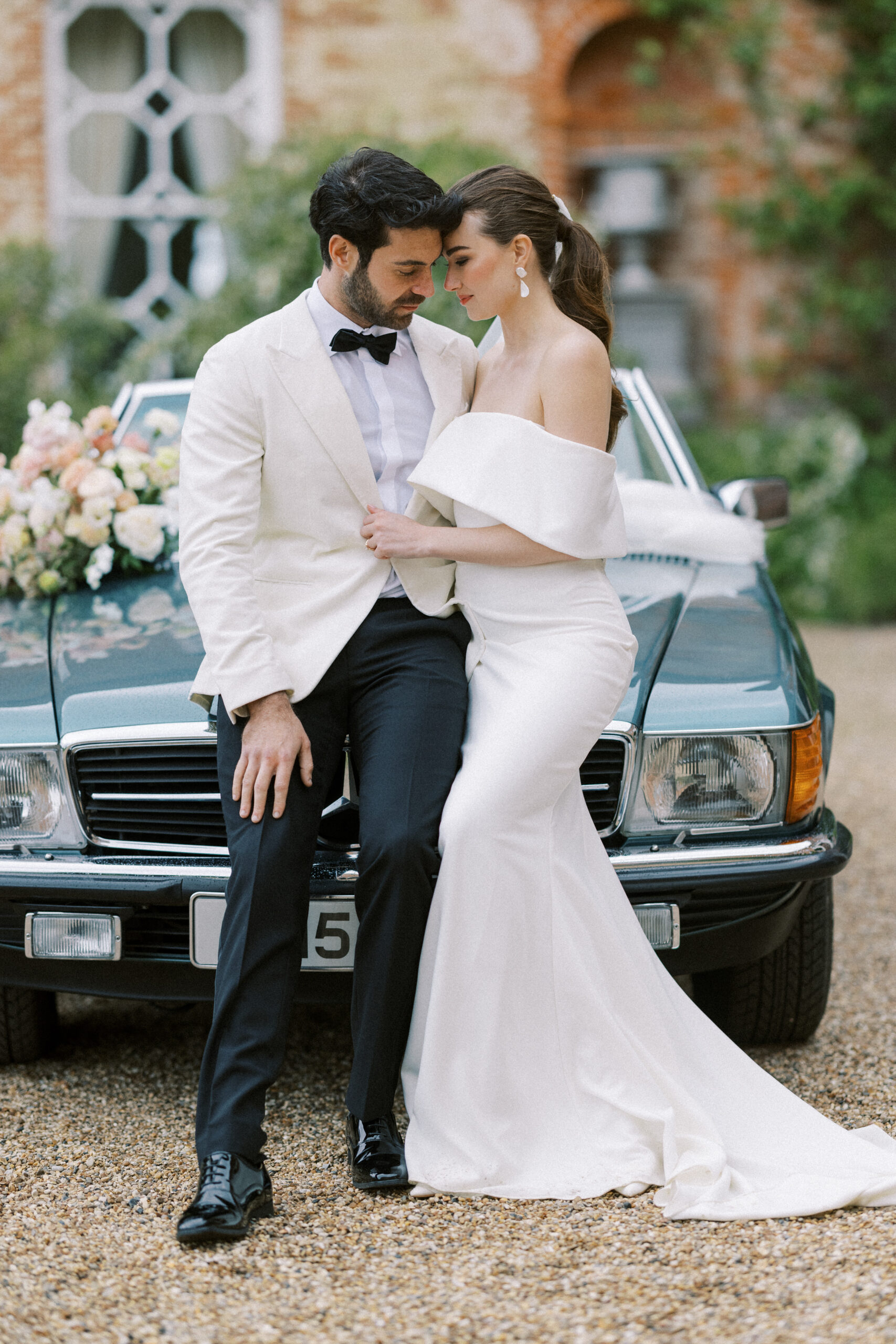 Wedding couple on their destination wedding day in Italy with their vintage wedding car