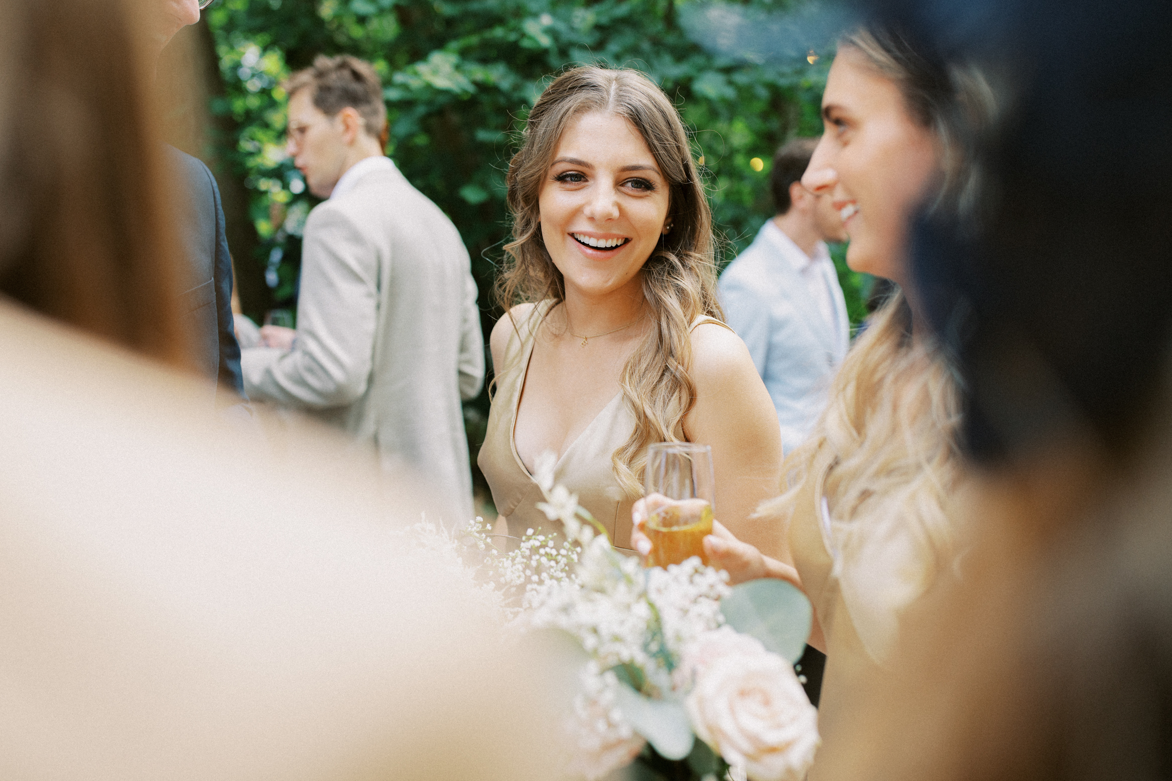 Candid wedding photograph of bridesmaid mingling at festival themed wedding at Wilderness Wedding venue in Kent