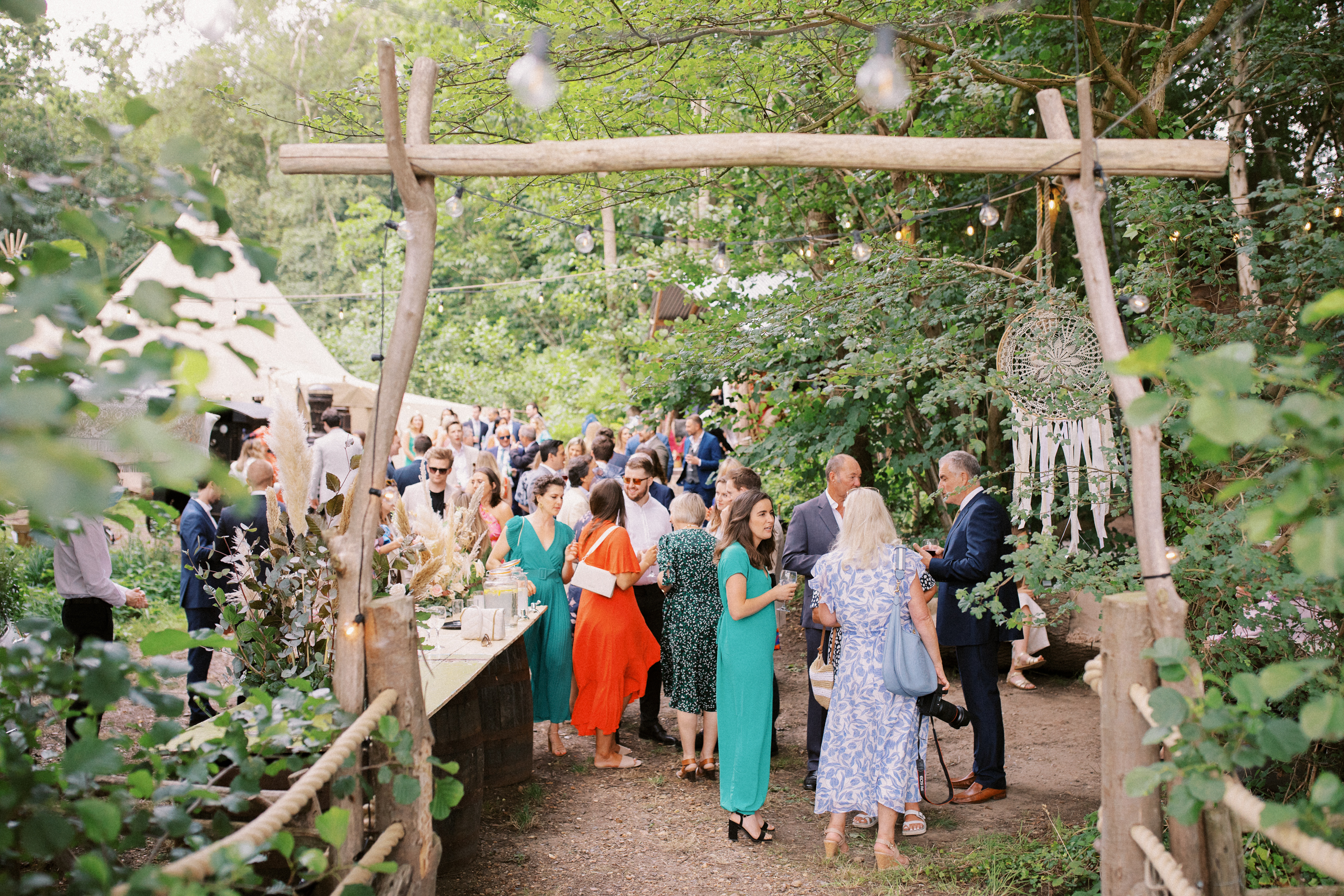 Candid wedding photography of guests chatting at The Wilderness Wedding Venue in Kent