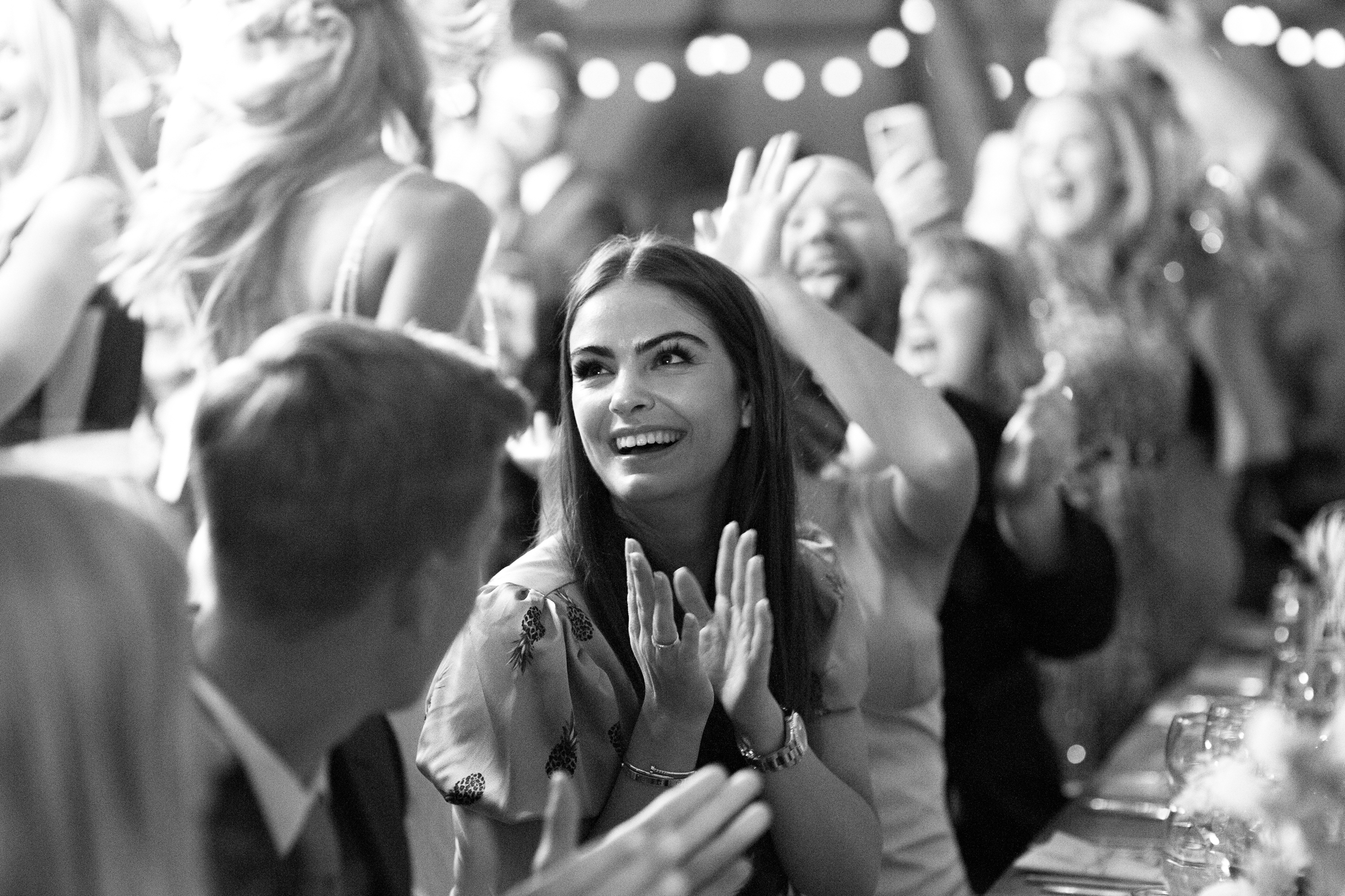 Guests greet bride and groom as they enter the tent at their festival themed wedding at Wilderness Wedding venue in Kent