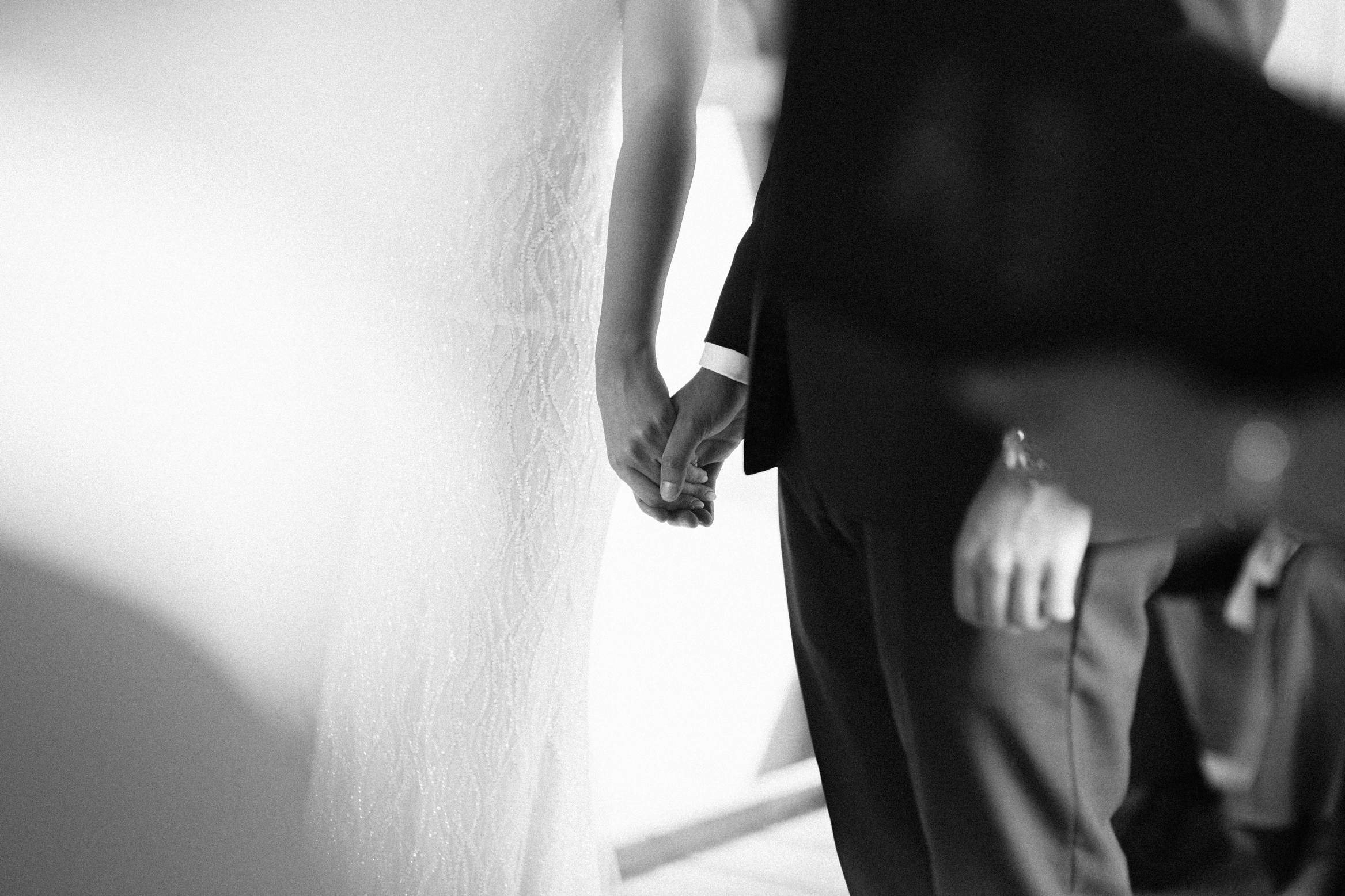 Bride and groom hold hands during their wedding ceremony at their Wilderness Weddings Wedding in Kent