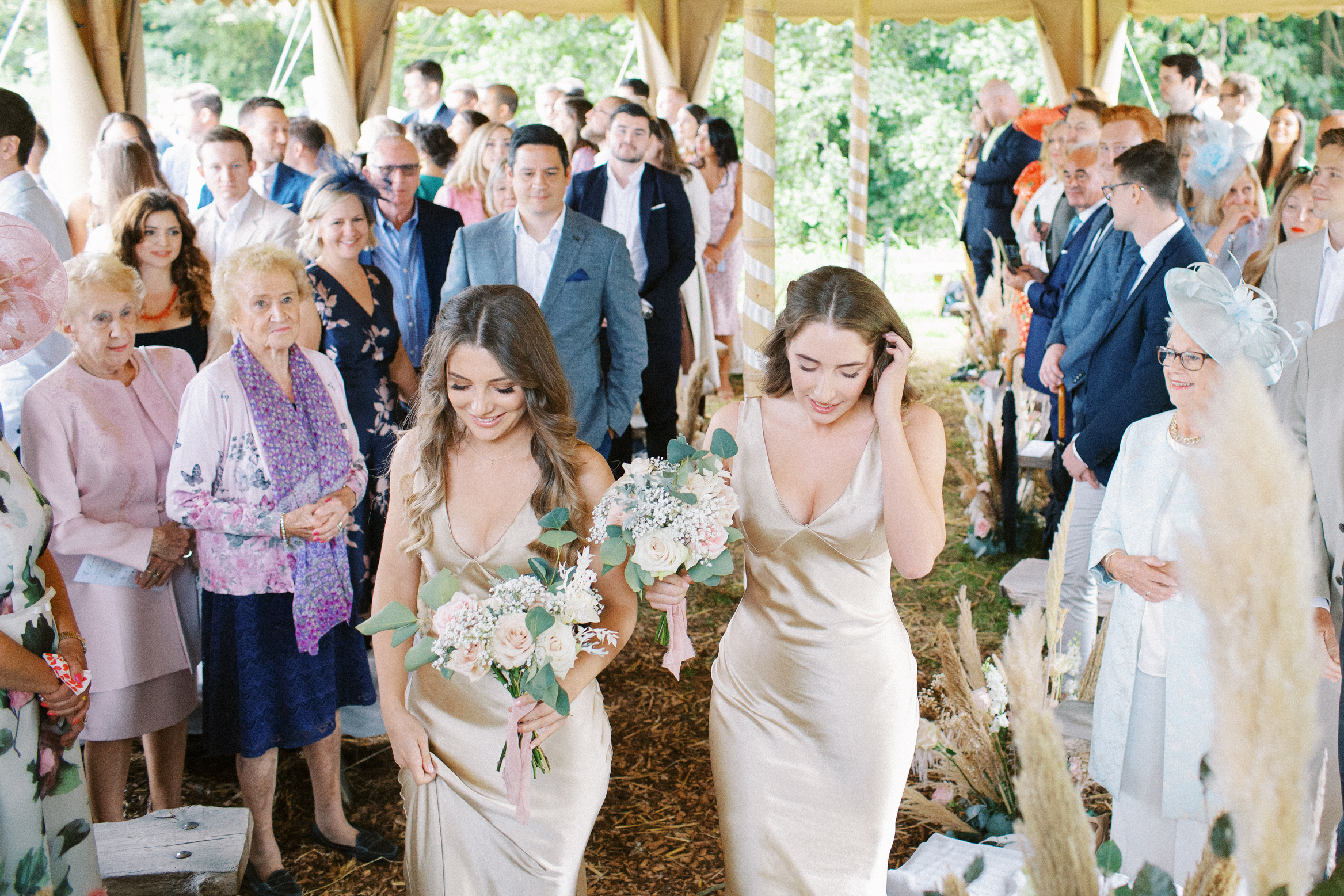 Bridesmaids walk through the Wilderness Weddings tent on wedding day