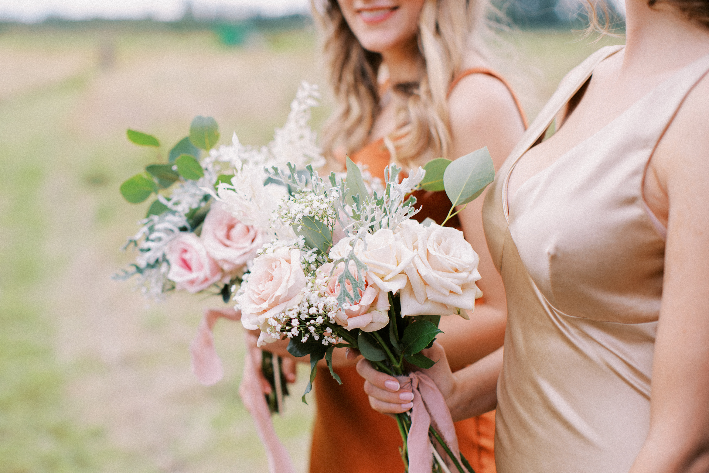 Candid wedding photography shot of bridesmaids and their flowers