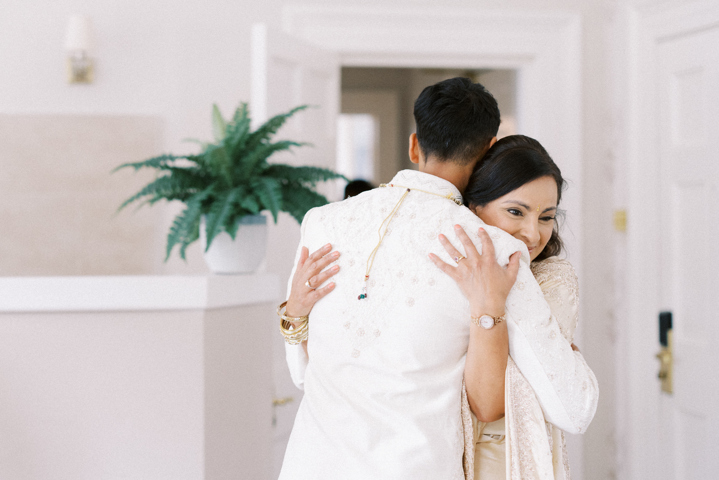 Groom and mum embrace on Indian wedding day at Burnham Beeches Hotel