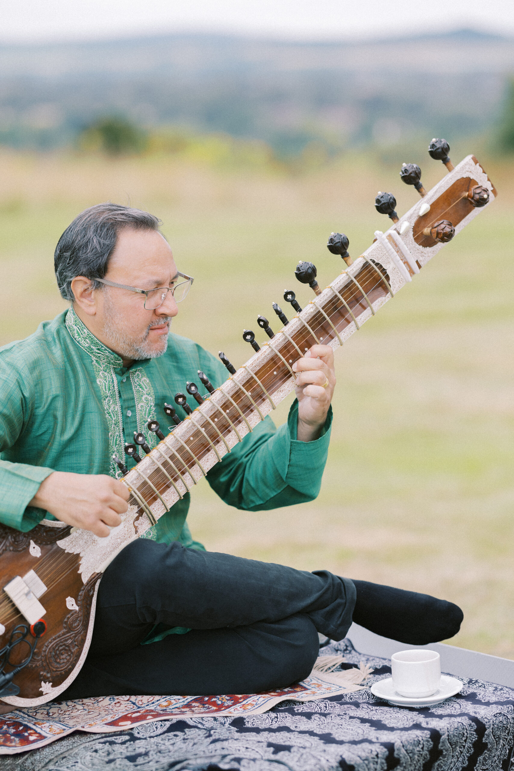 Gentleman plays an instrument ahead of an Indian wedding