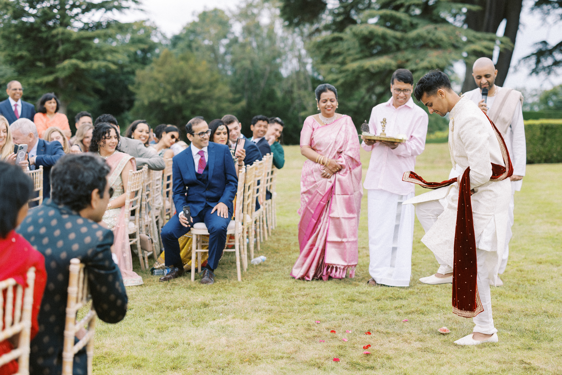 Groom breaks the clay pot on his wedding day in the grounds of the beautiful Hedsor House