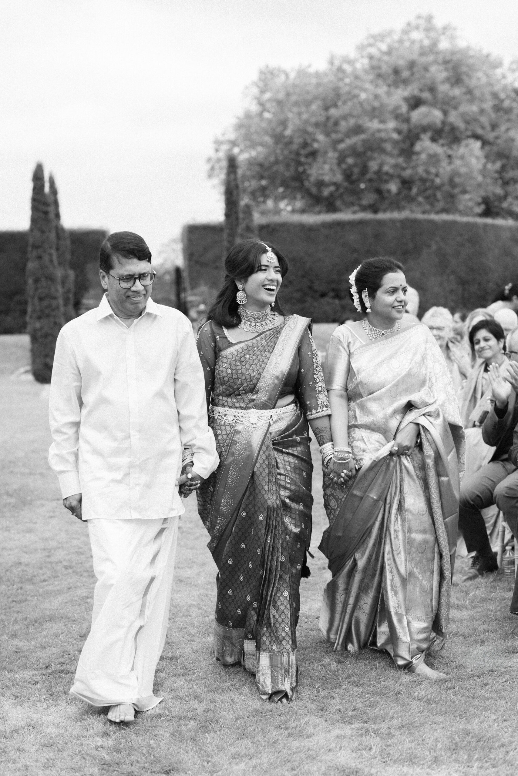 Bride laughs as she walks down the aisle during her wedding ceremony