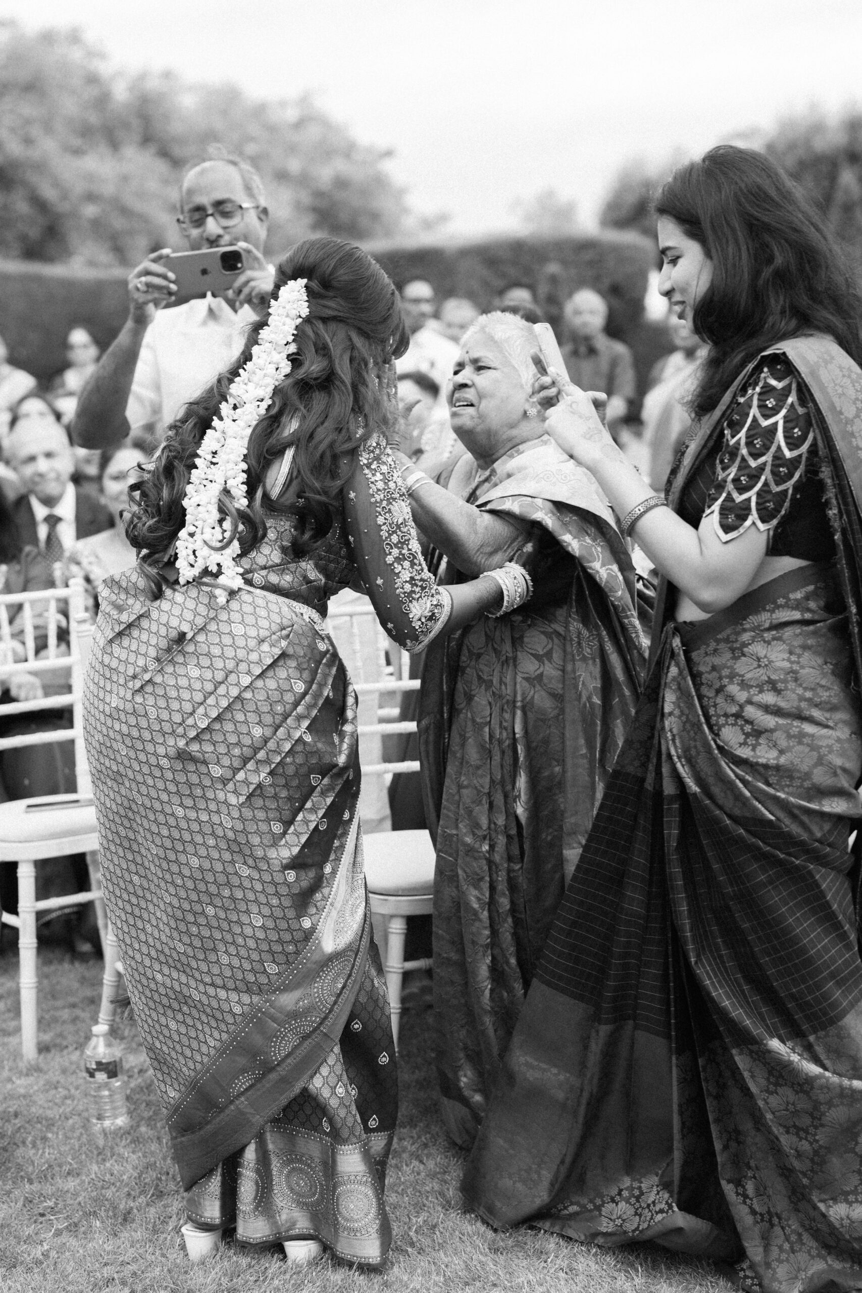 Bride embraces her aunty as she walks up the aisle on her wedding day