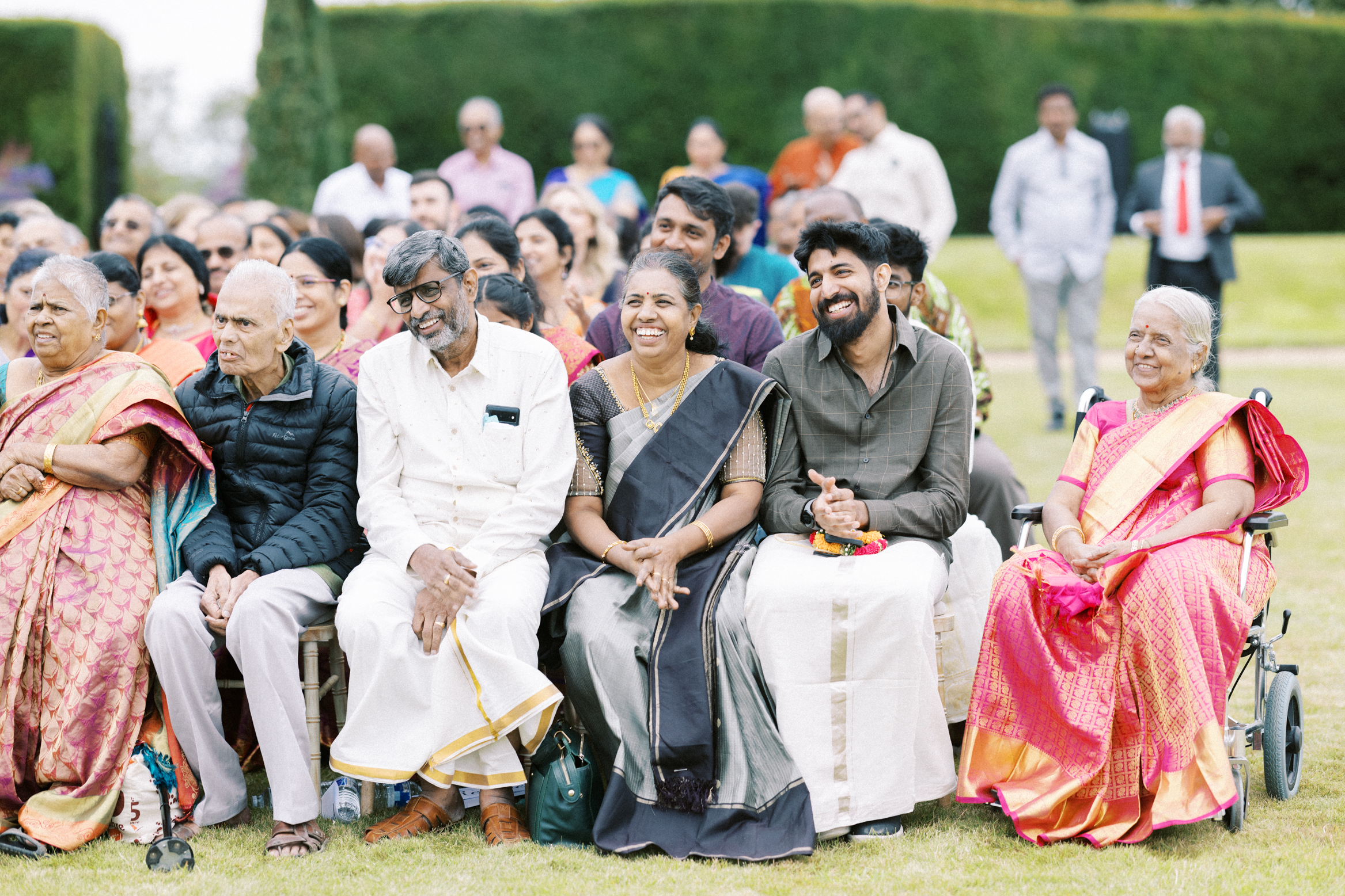 Guests smile during an Indian wedding service