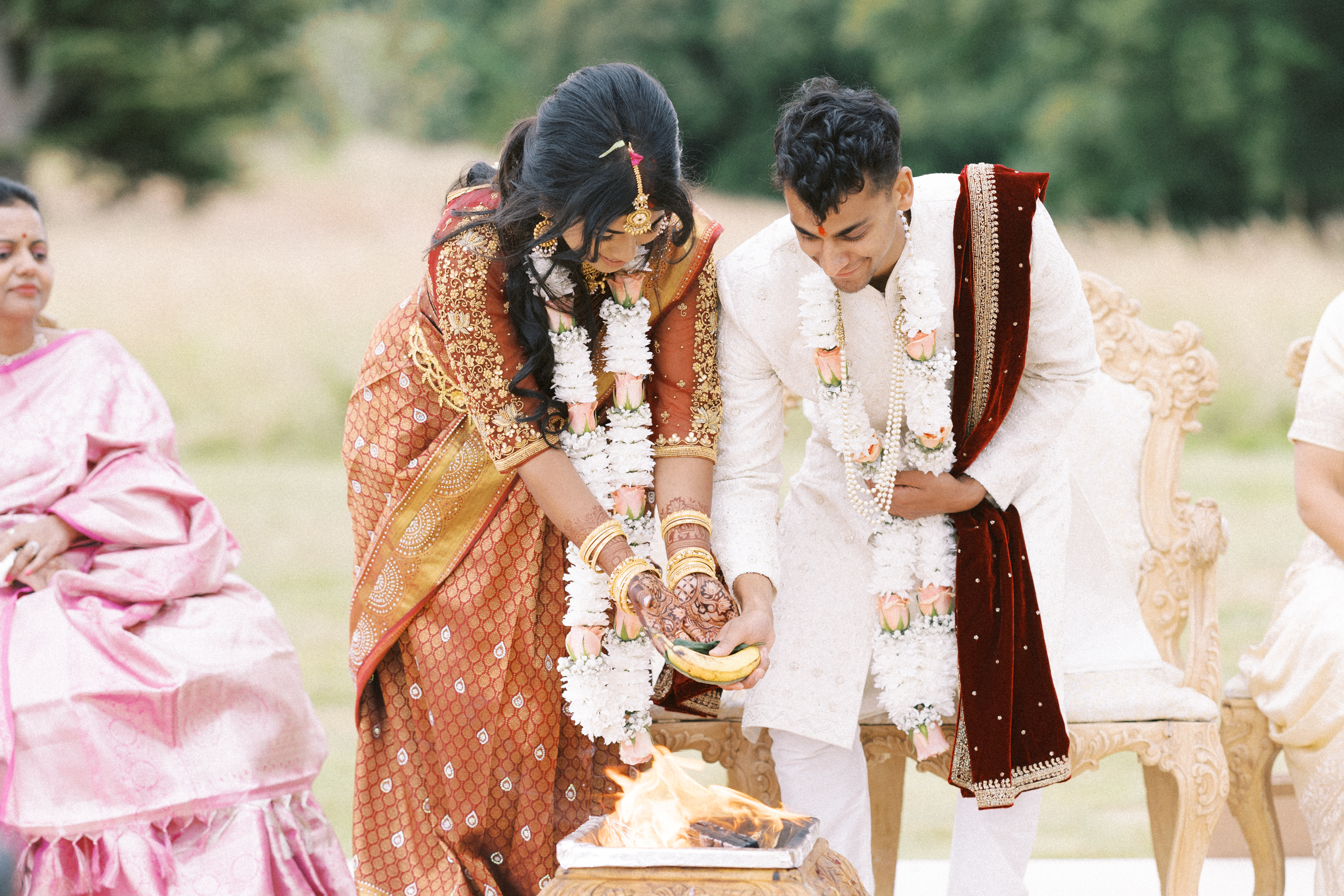 Bride and groom perform Indian rituals on their wedding day