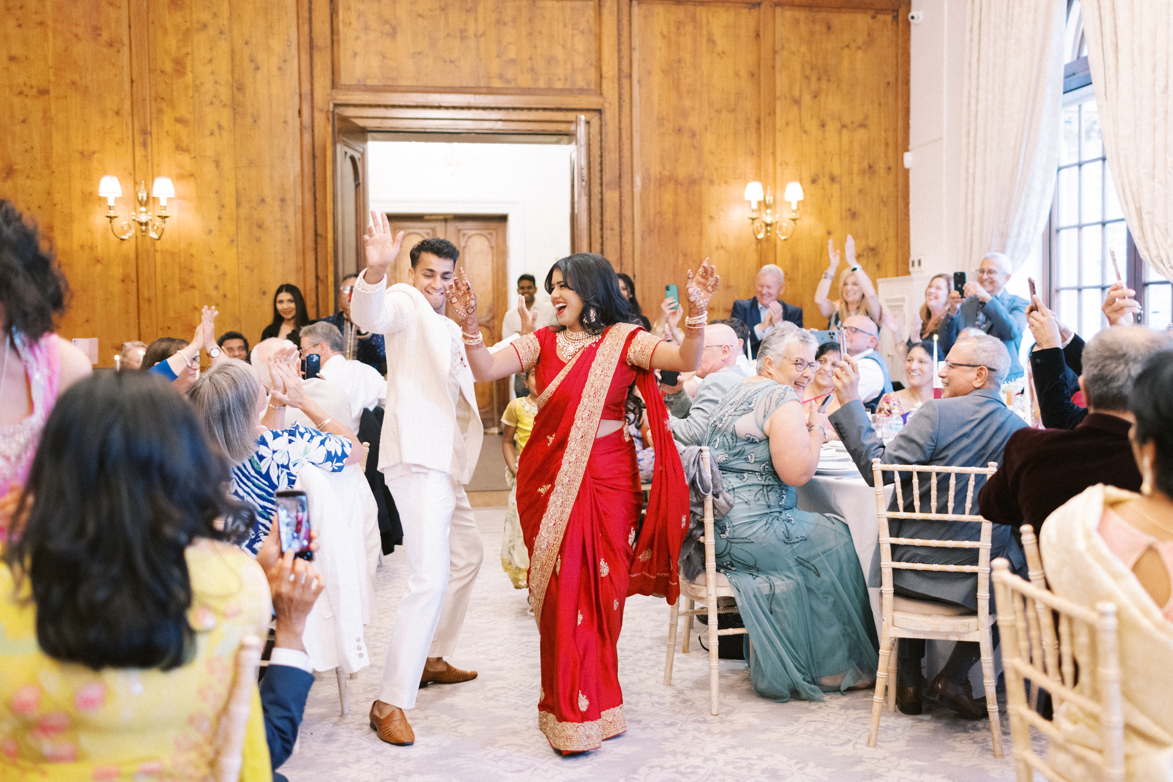 Bride and groom enter the ballroom on their wedding day at Hedsor House