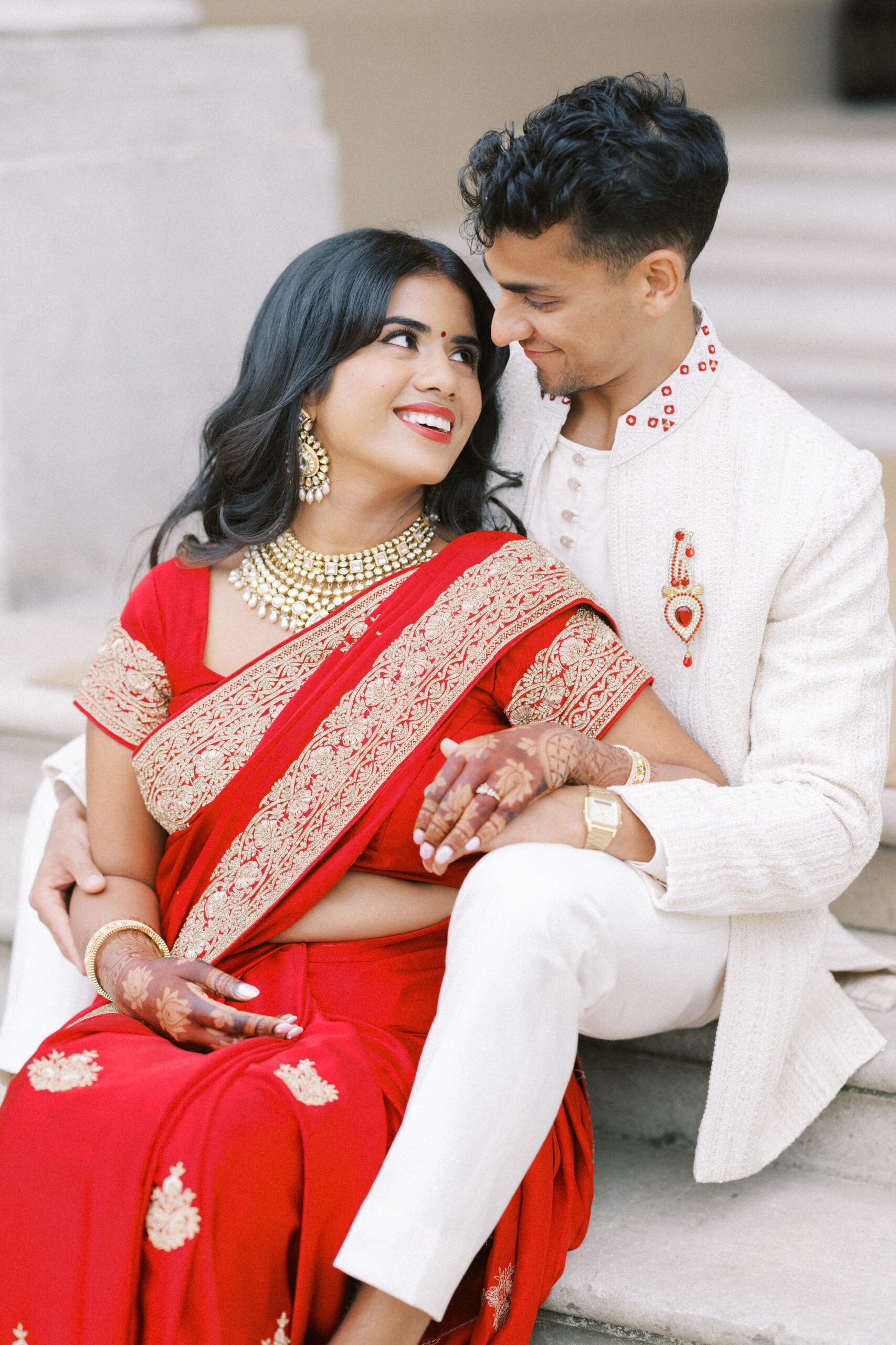 Indian couple embrace on the steps at Hedsor House