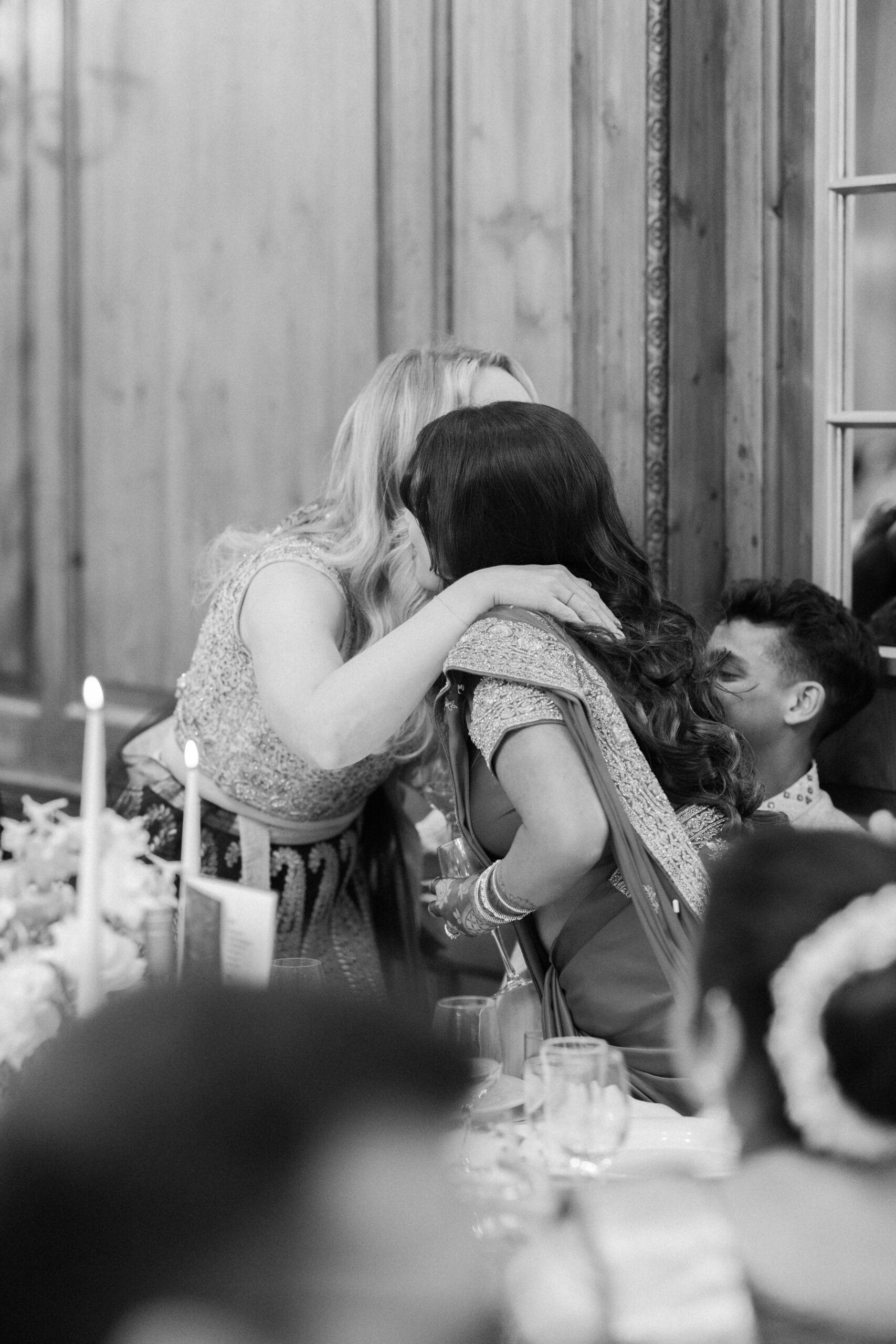 Bride and best friend hug during wedding day speeches