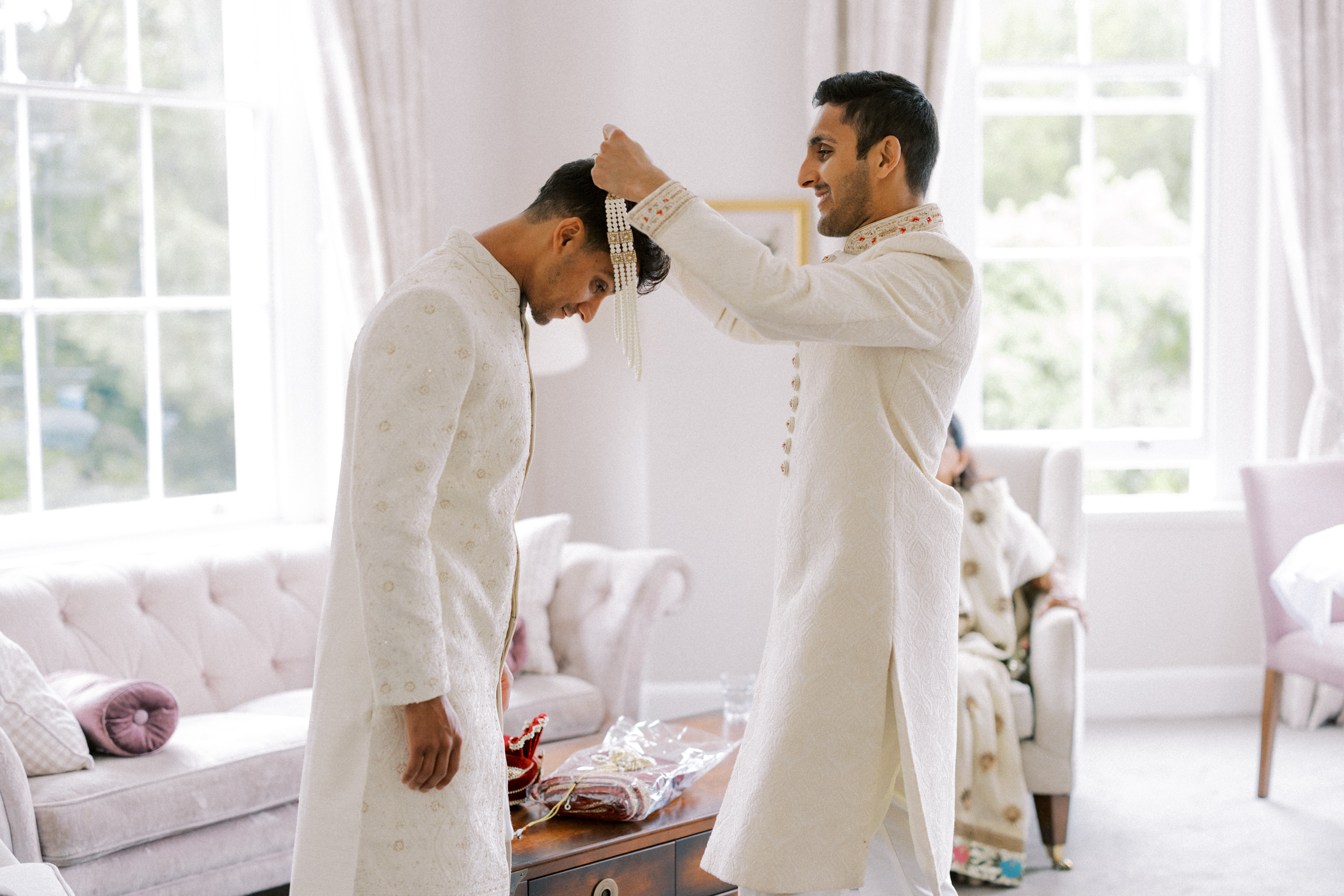 Best man helps groom get ready at Burnham Beeches Hotel