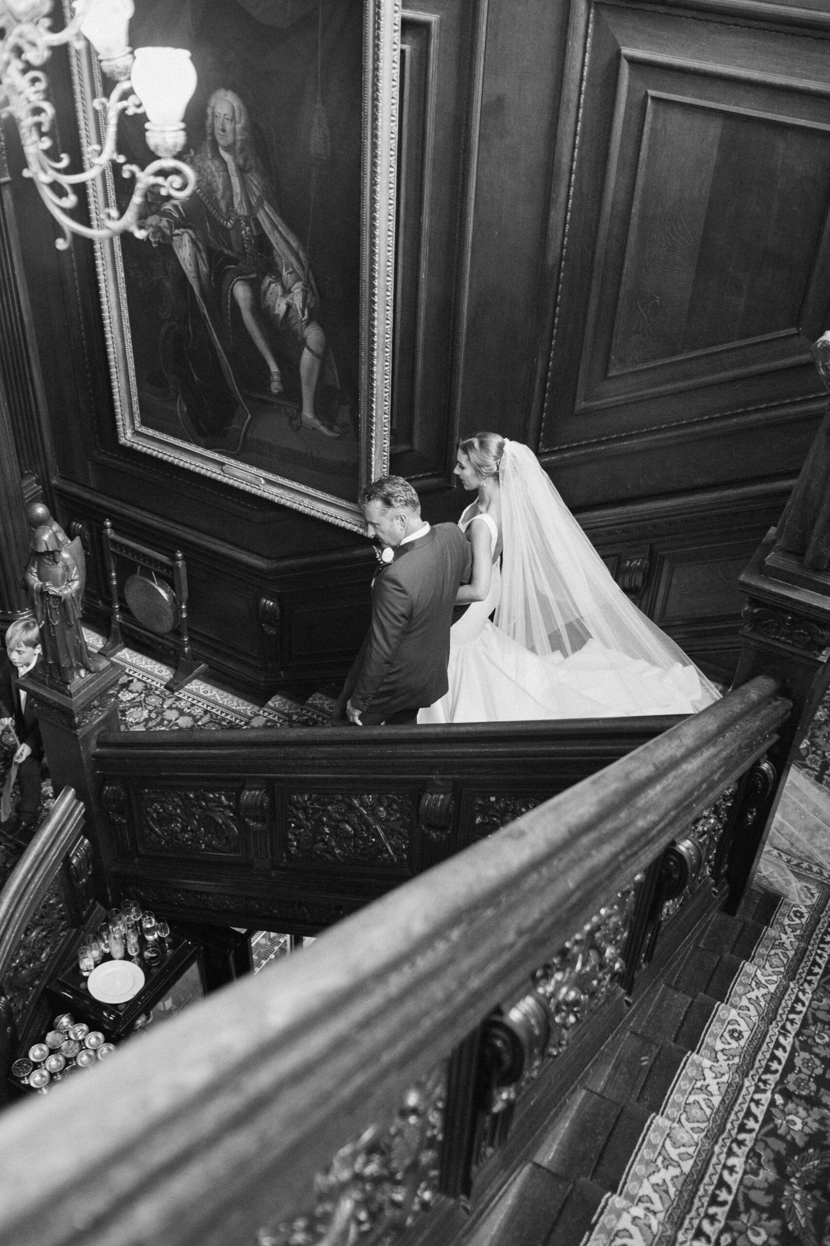 Bride walks down the stairs on her wedding day at Cliveden House