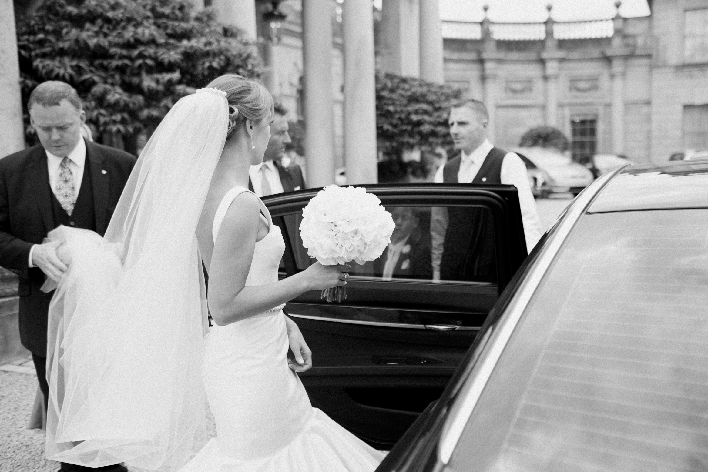 Bride gets into the car on her wedding day at Cliveden House