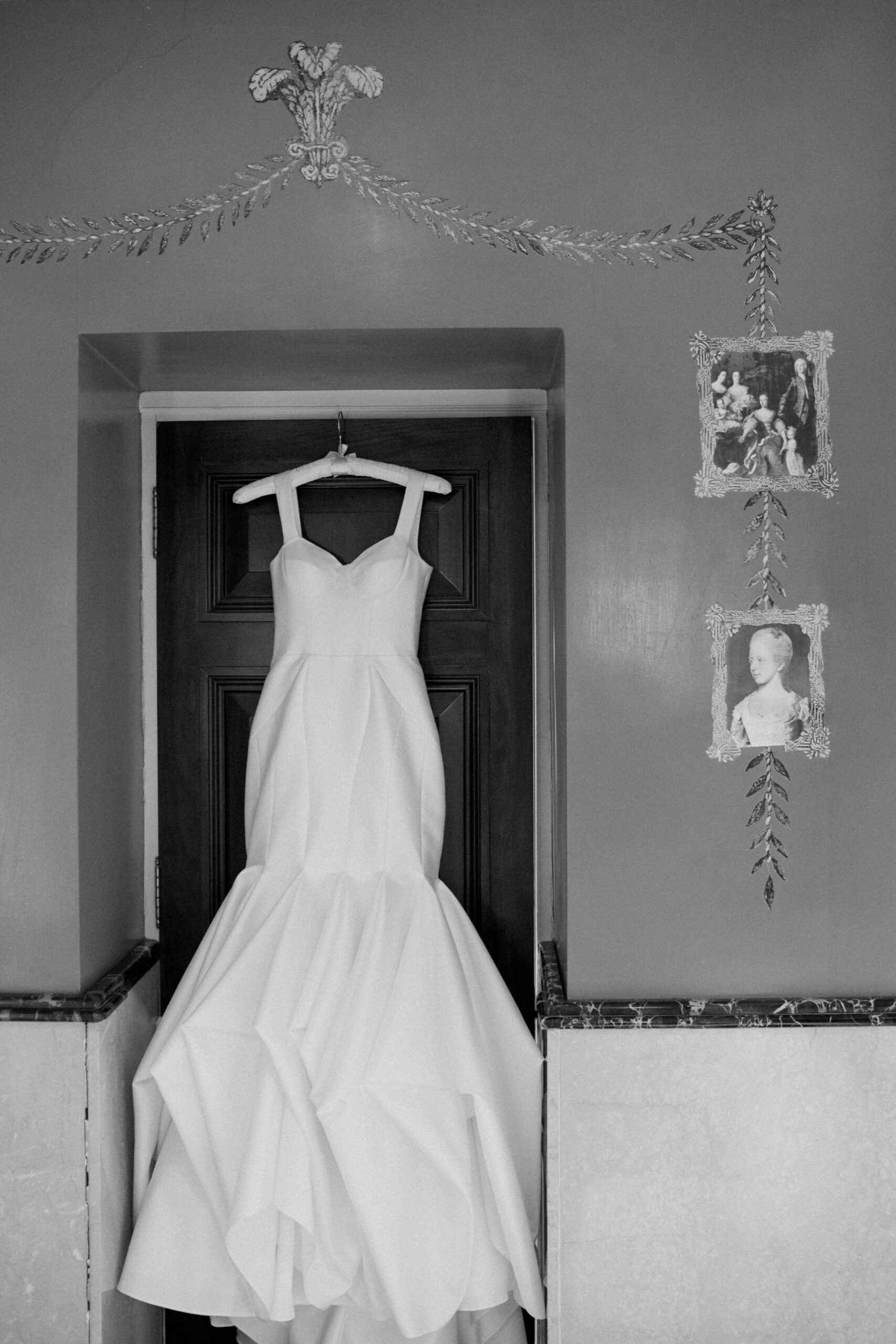 Editorial wedding photograph of bridal gown hung up at Cliveden House Wedding venue