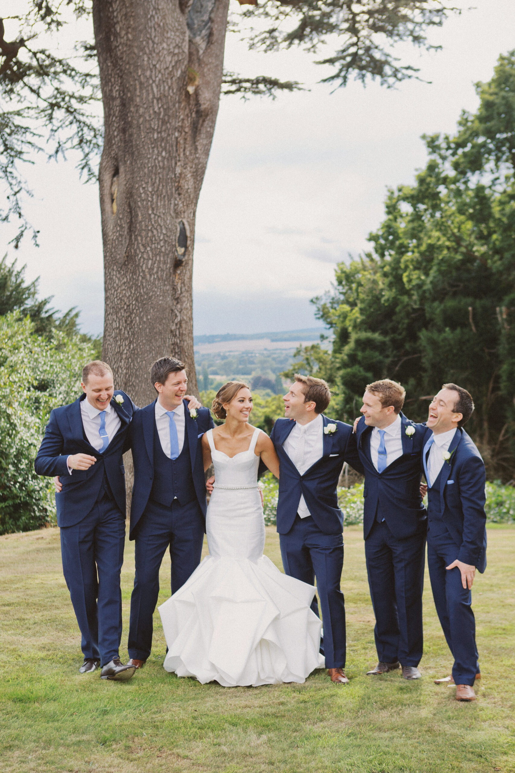 Bridal party laugh at Hedsor House wedding