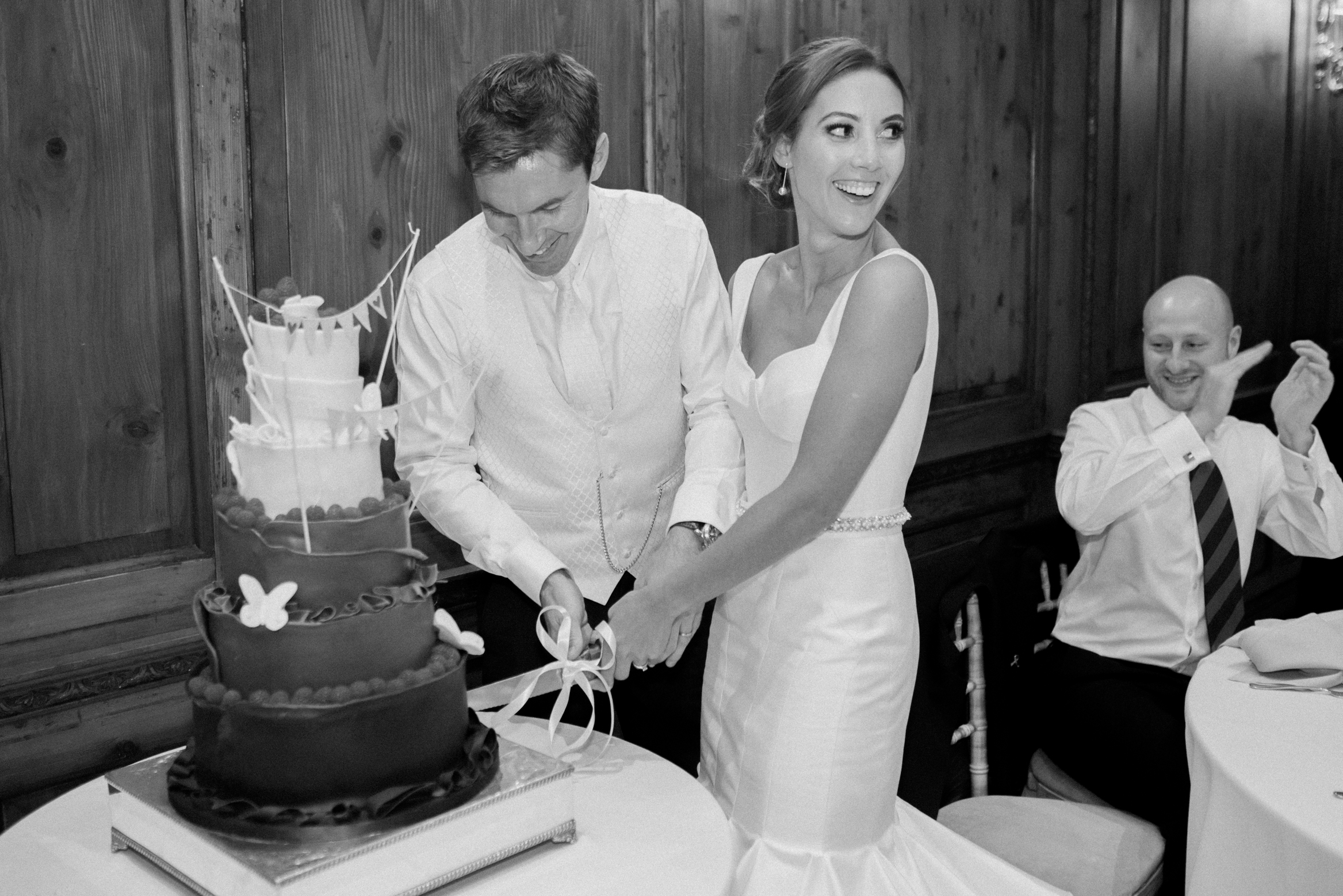 Bride and groom cut the cake on their wedding day