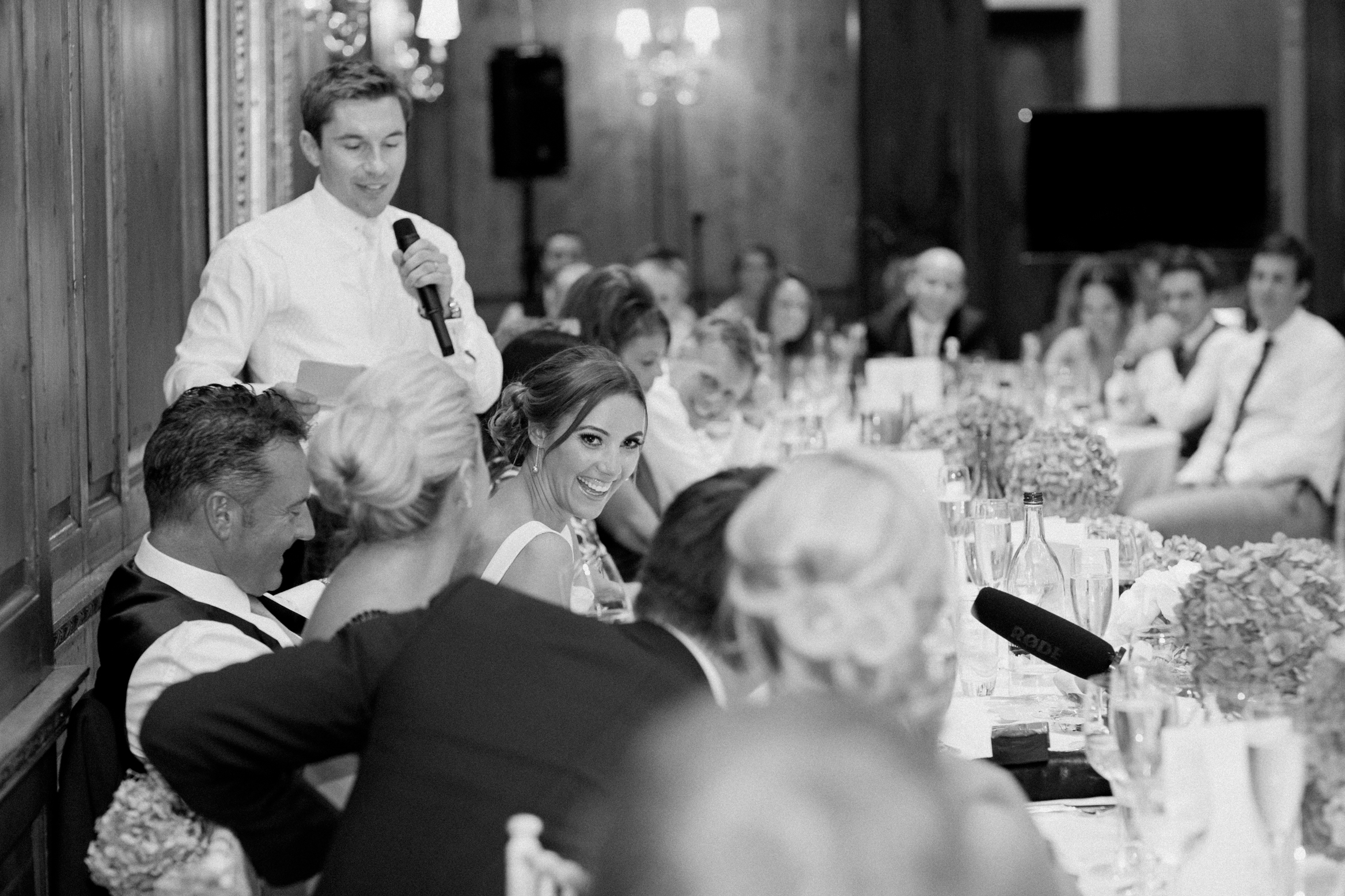 Bride laughs during the speeches in Hedsor House's ballroom on her wedding day