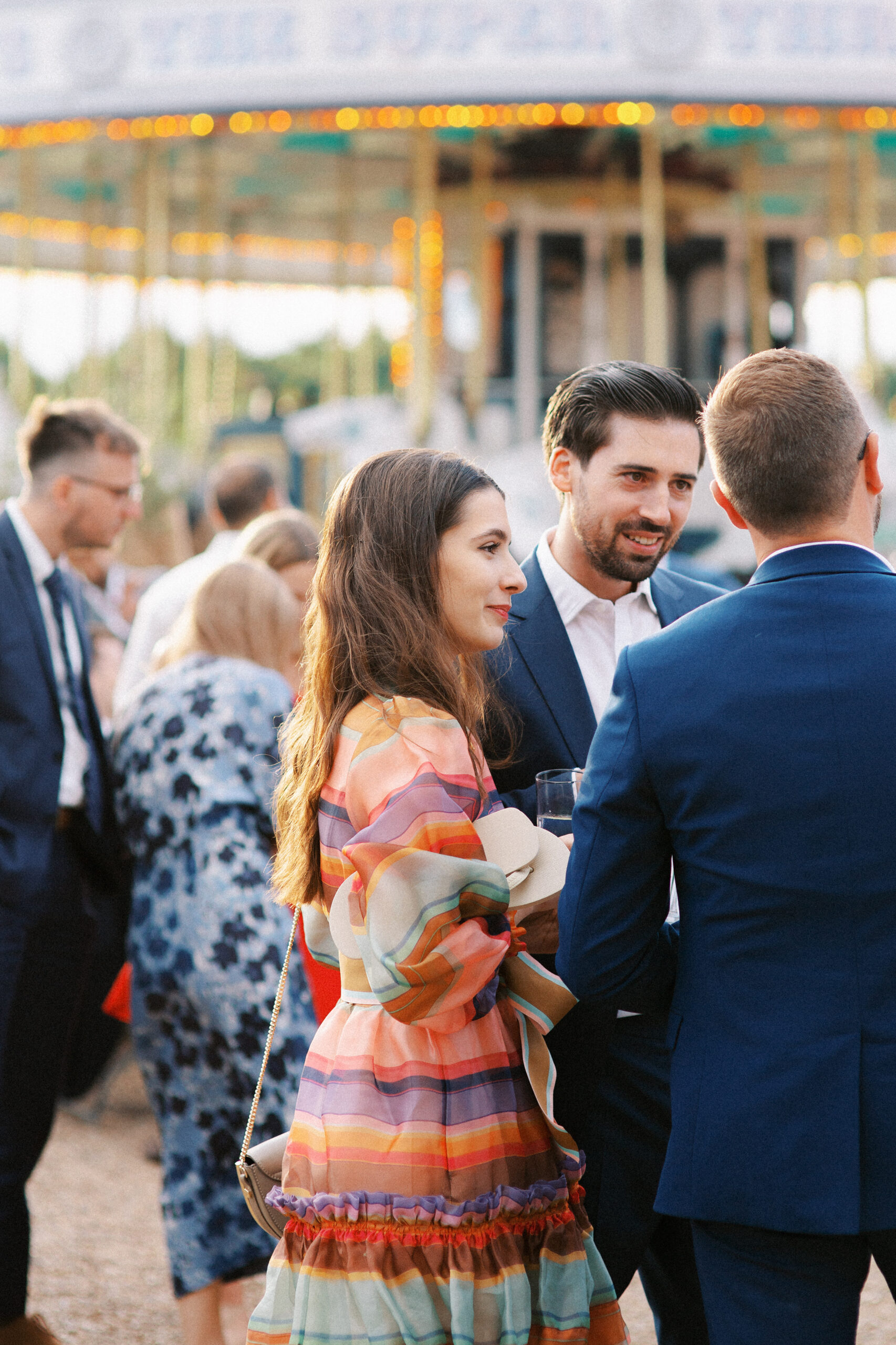 Guests mingle at festival themed Preston Court Wedding in Kent