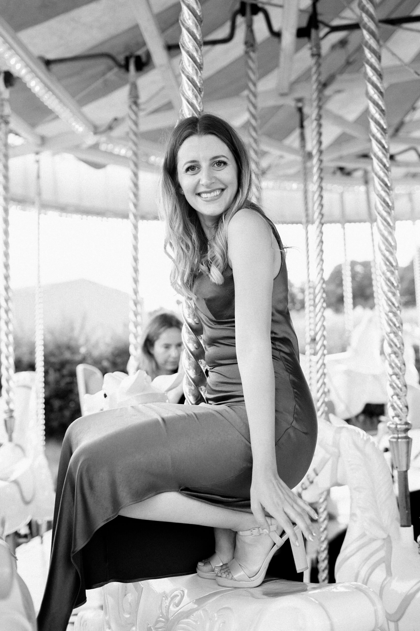 Bridesmaid smiles on the carousel at Preston Court Wedding Venue in Kent