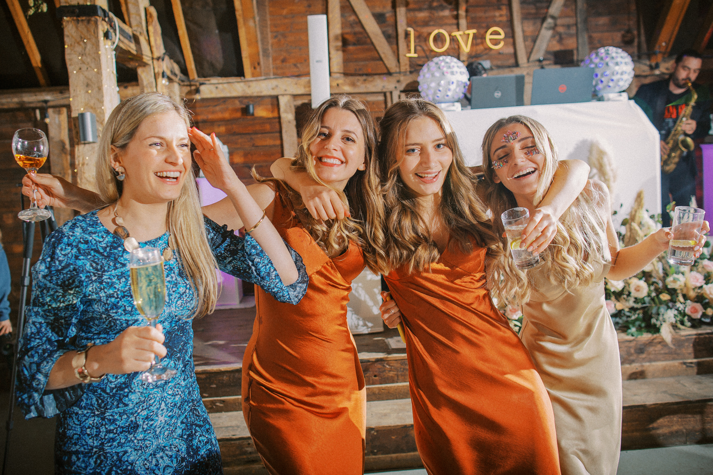 Guests laugh and dance on Preston Court's dance floor at festival themed Preston Court Wedding