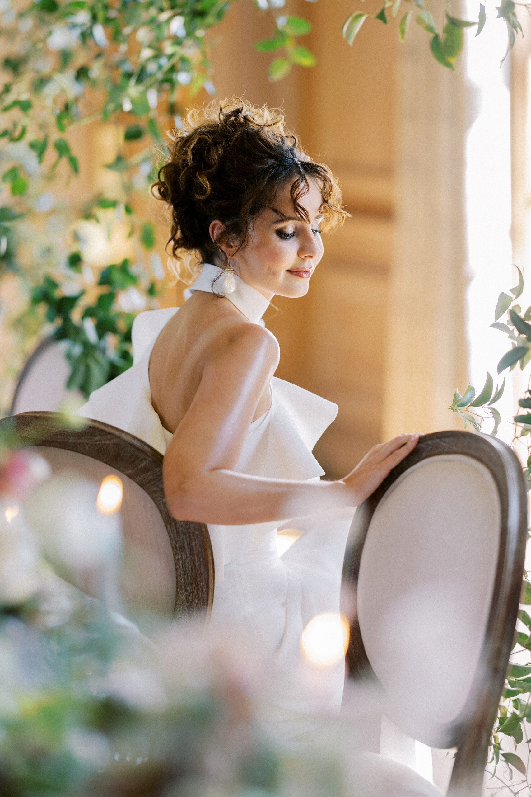Bride sits within the wedding breakfast table at Findon Place