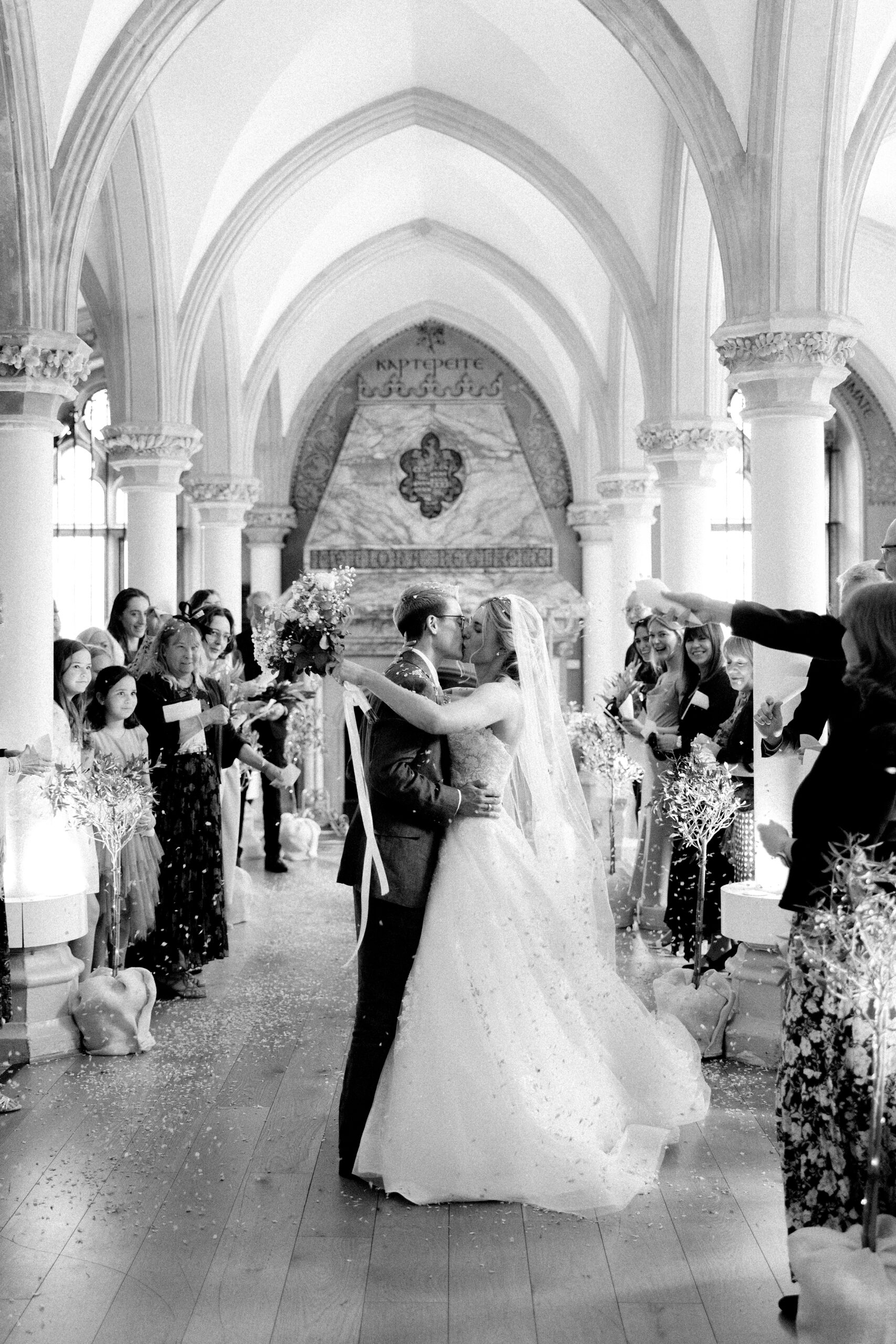 Documentary wedding photography capturing a couple kiss after their wedding ceremony at Wotton House