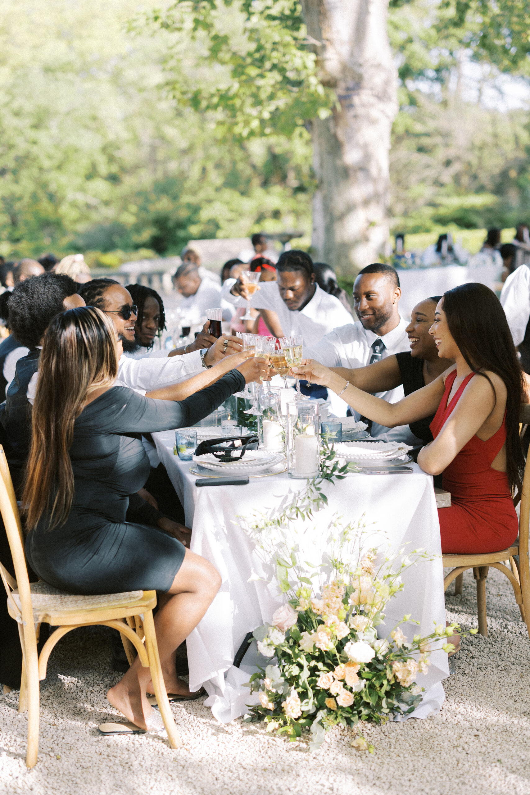Guests cheer at long tables during destination wedding