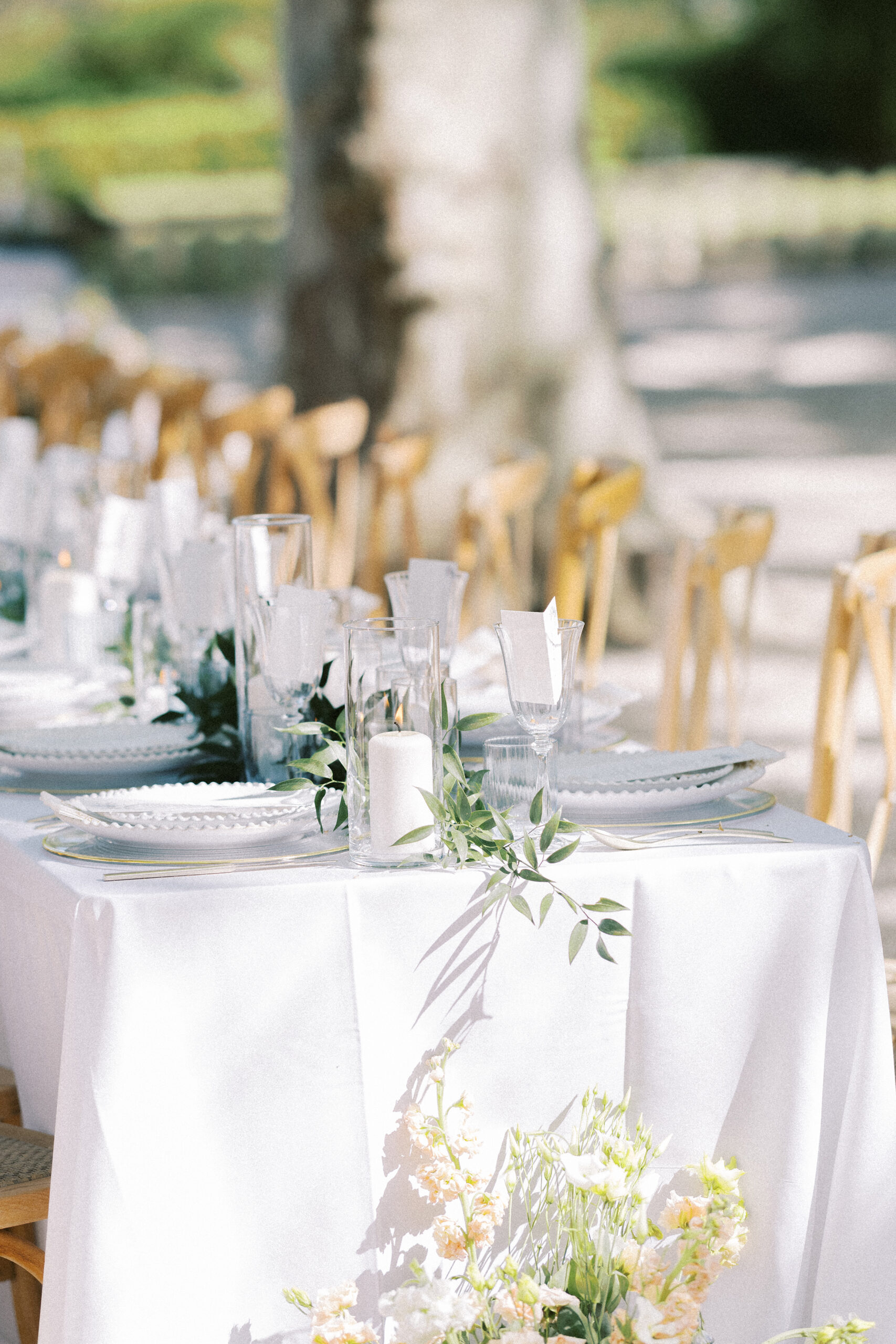 Destination wedding breakfast setup in the stunning Provence countryside, with long tables draped in linens and glowing fairy lights at Château de Valmousse