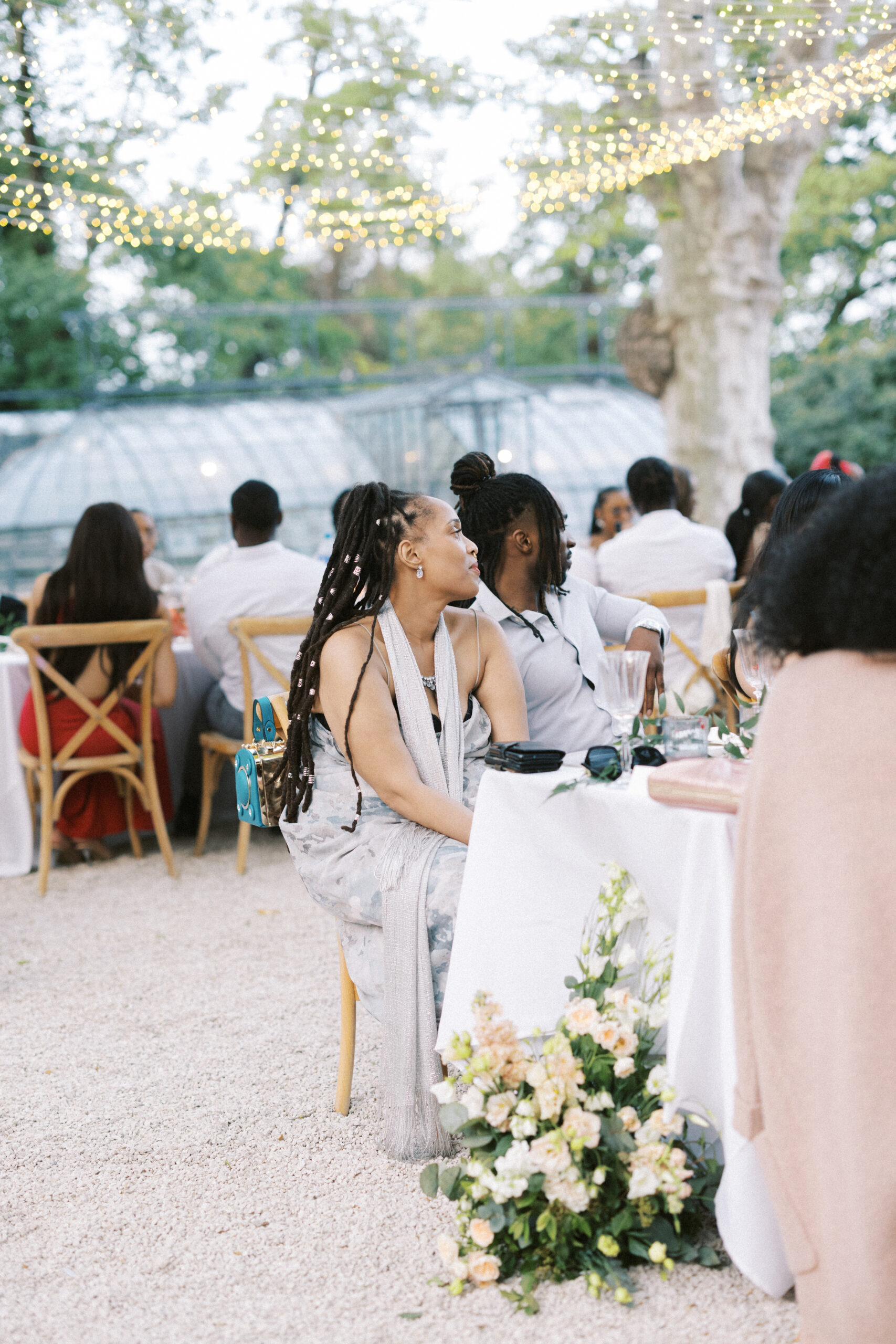 Guest listens to the speeches during an al fresco style wedding breakfast at Chateau de Valmousse