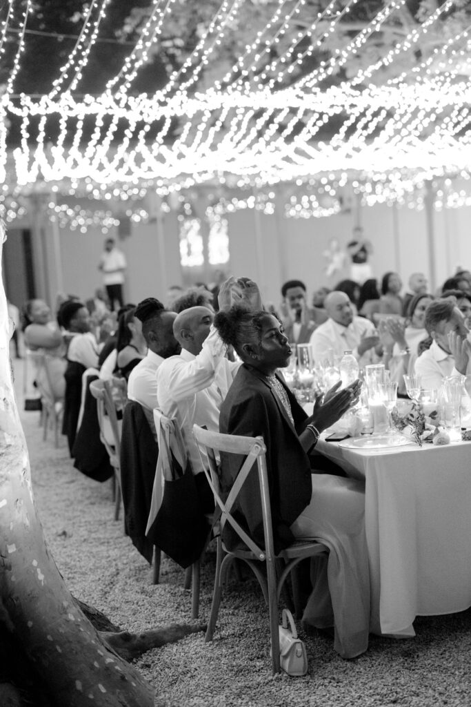 Guests raising glasses for a toast at a luxury French destination wedding