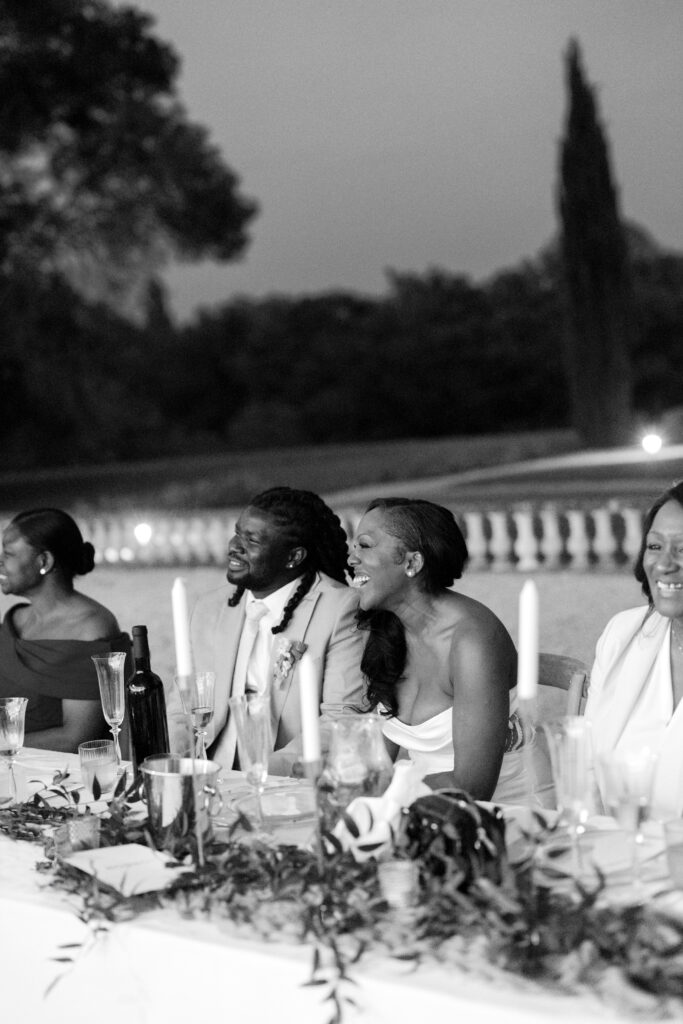 Bride and groom laughing during wedding toasts at a Provence chateau wedding