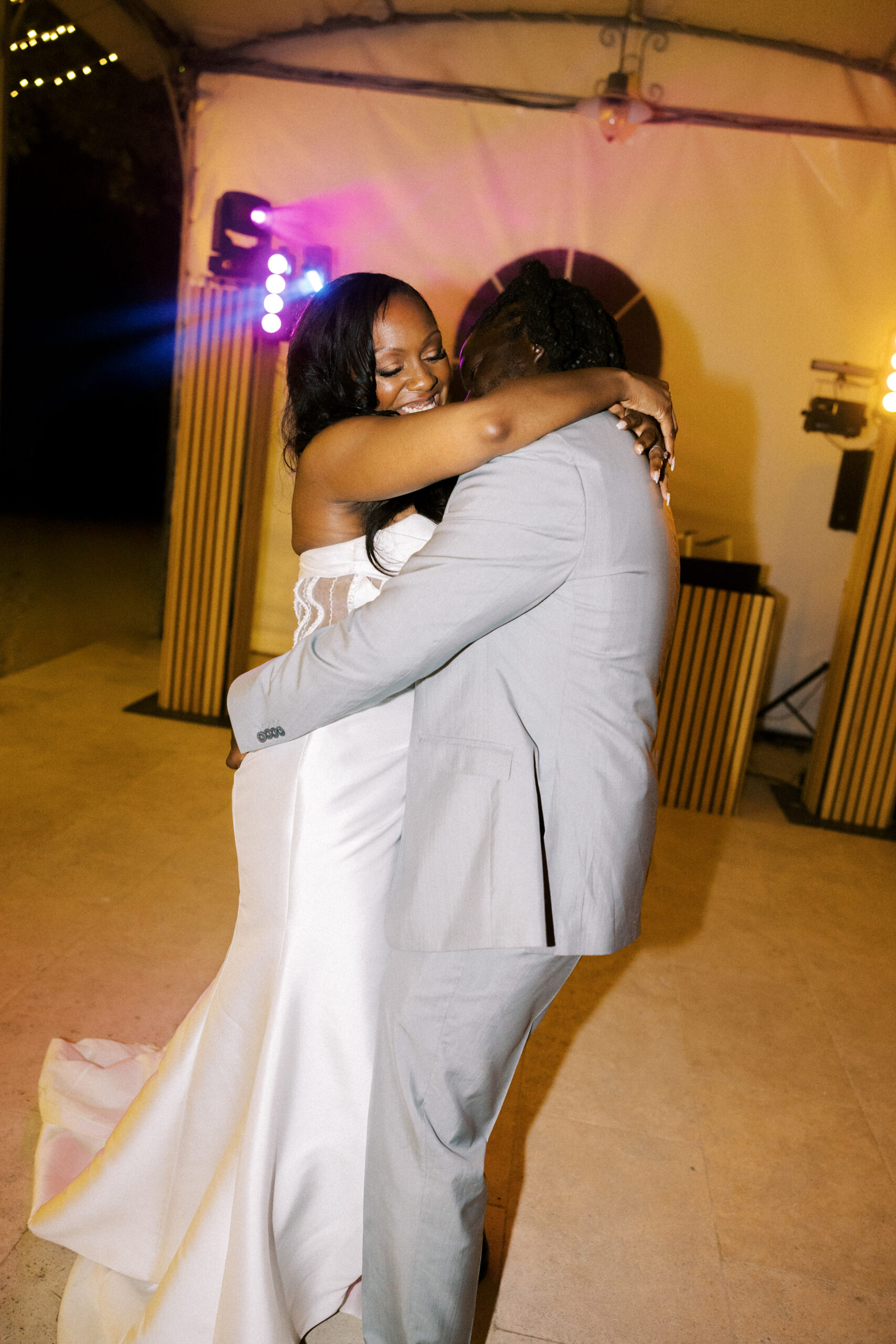 Bride and groom laughing on the dance floor at Chateau de Valmousse, photographed by a French destination wedding photographer