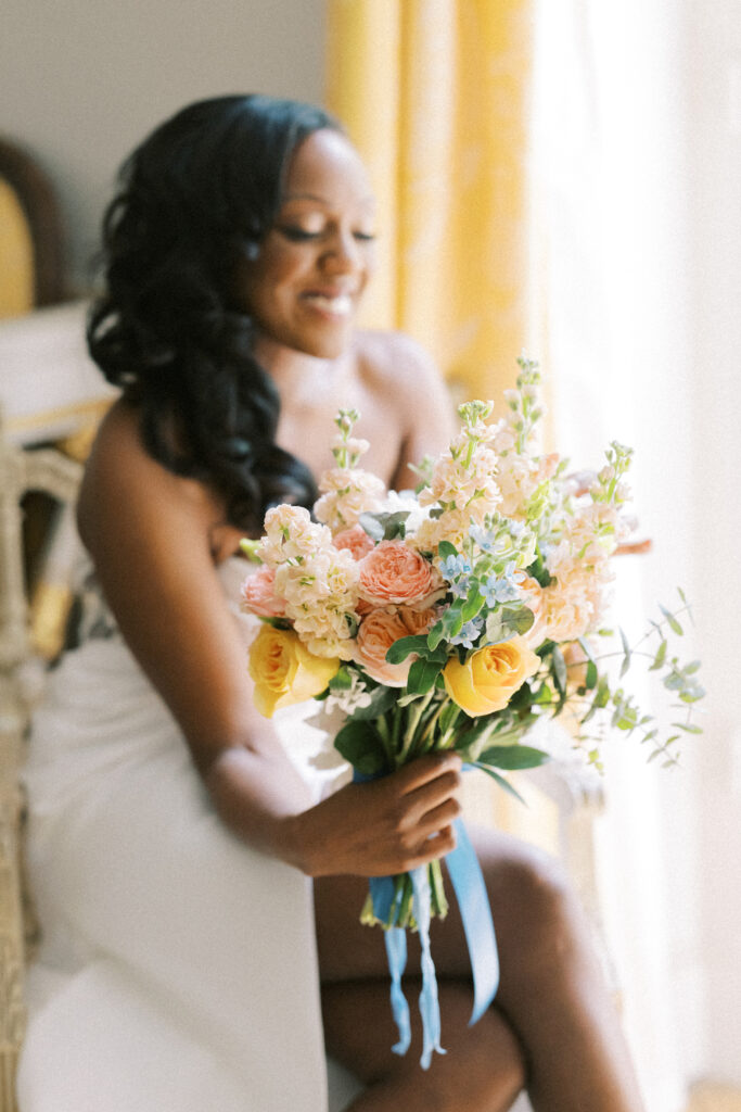 Bride holds her bouquet before her wedding day