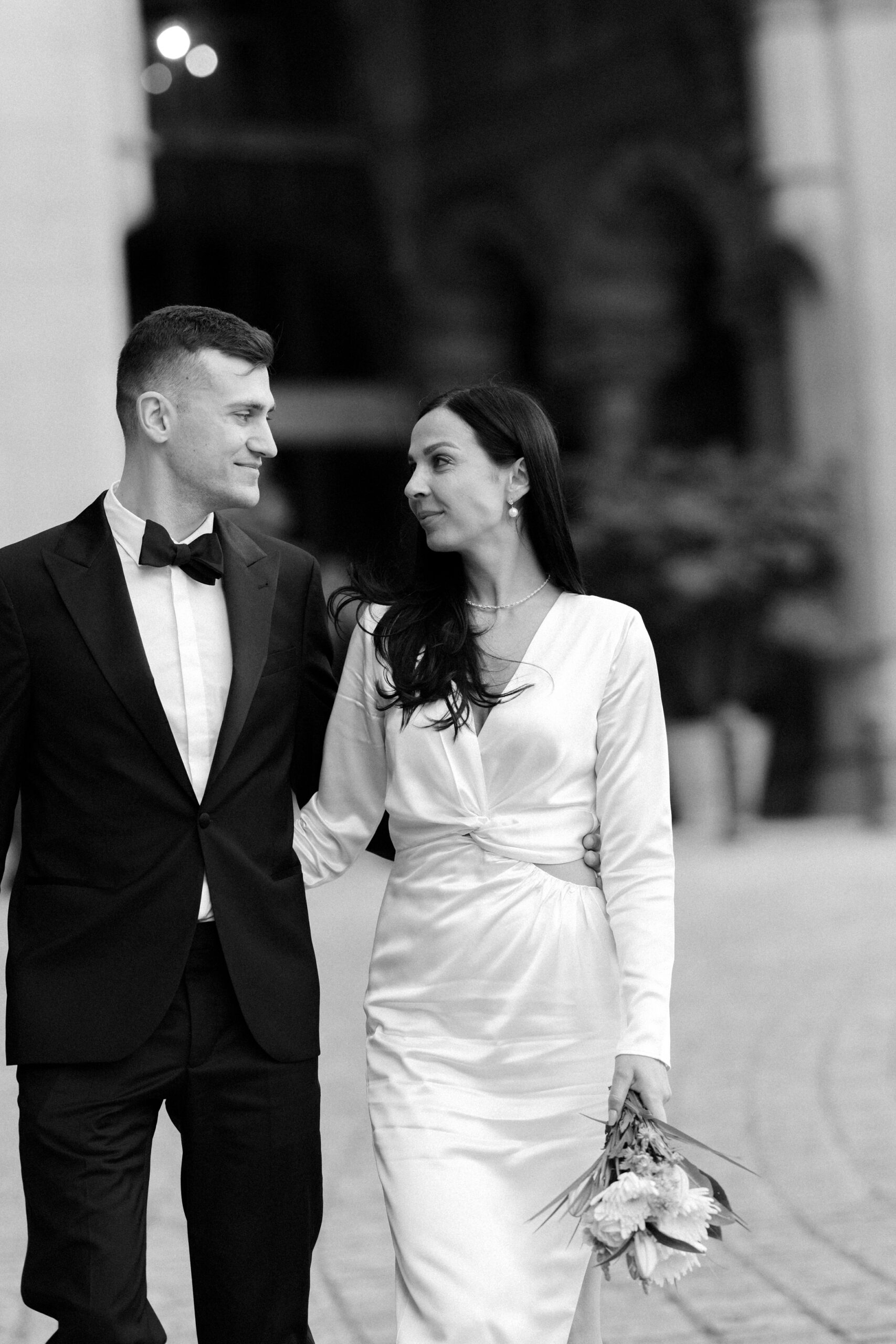 Couple laughing together outside St Pancras International before dinner