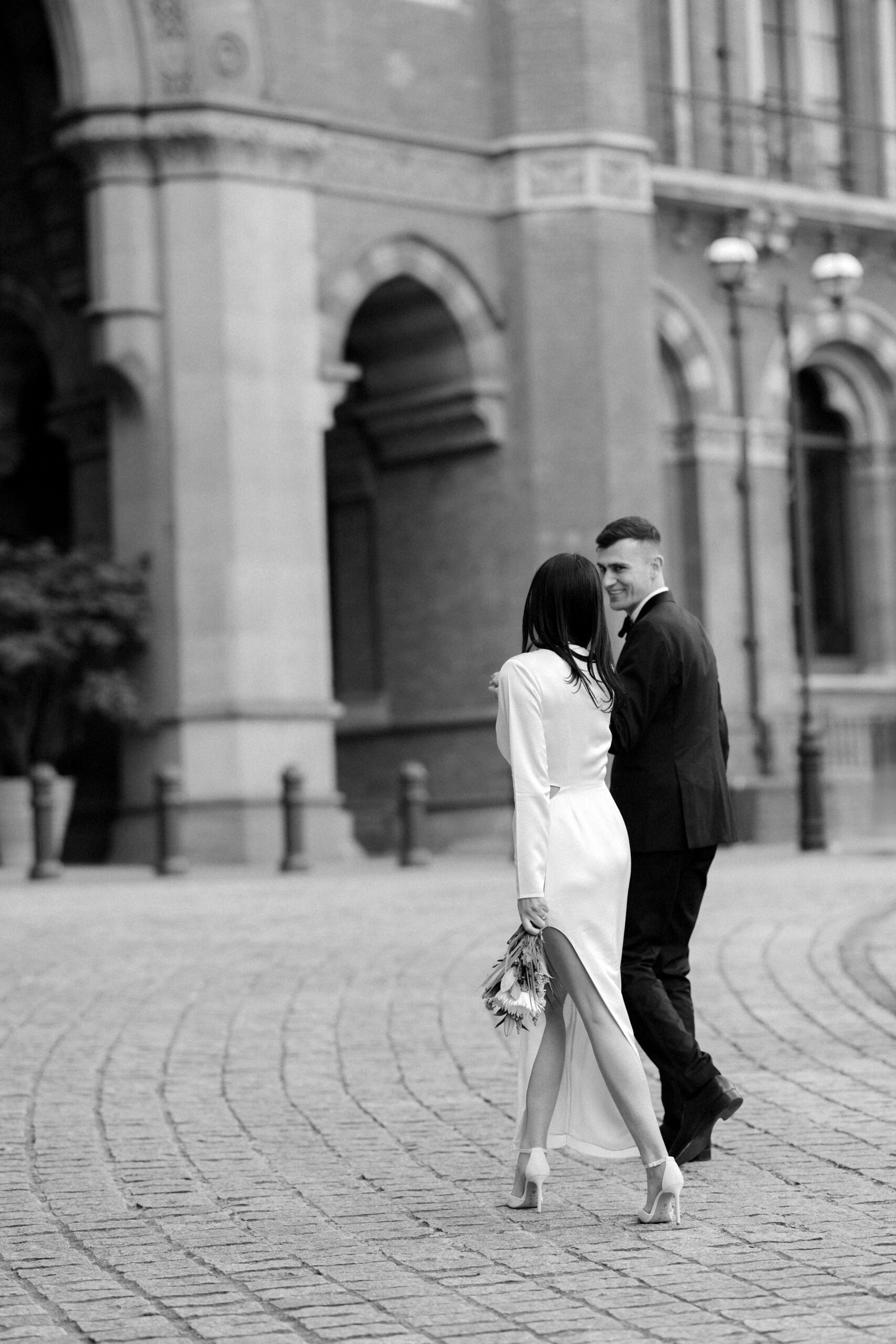 Newlywed couple walking outside St Pancras station after their Marylebone Town Hall wedding
