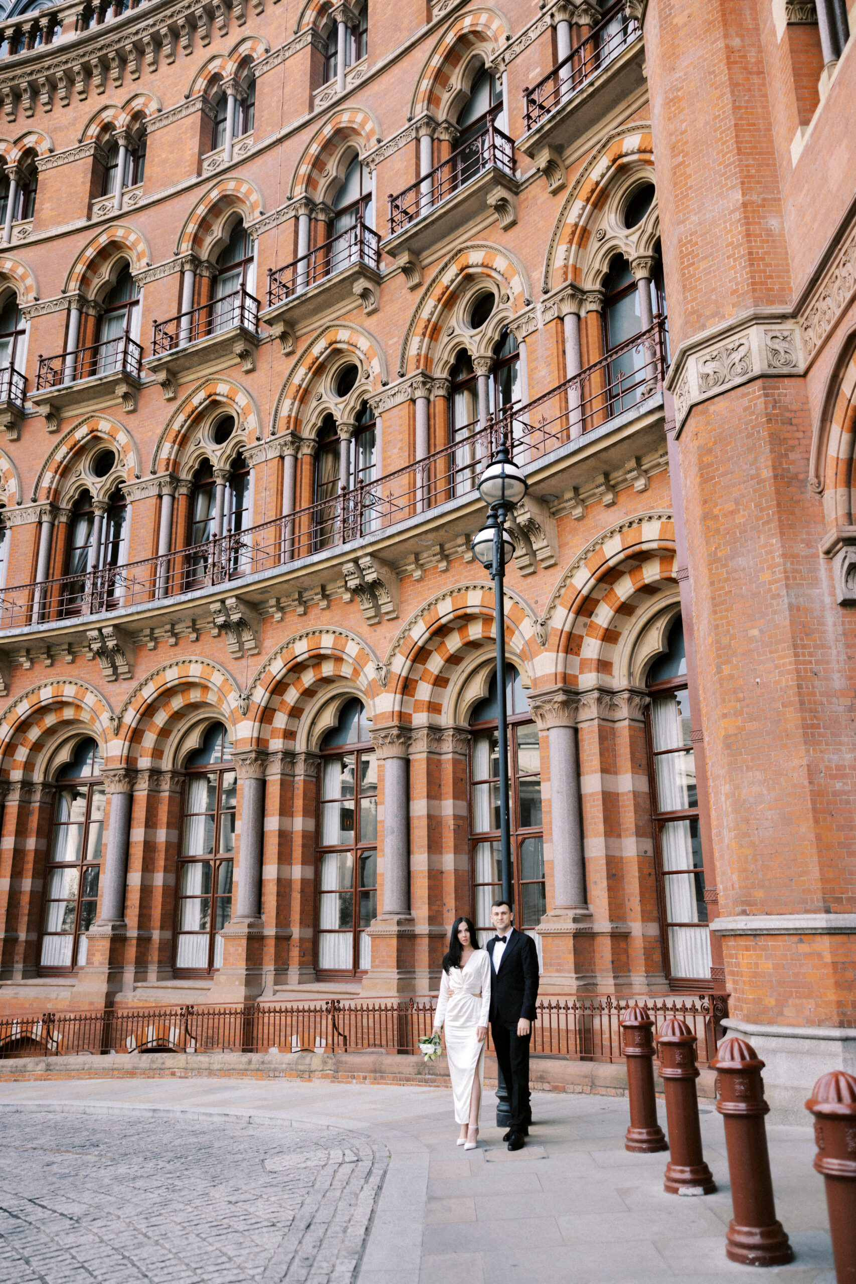 Relaxed wedding portraits of bride and groom at St Pancras London”