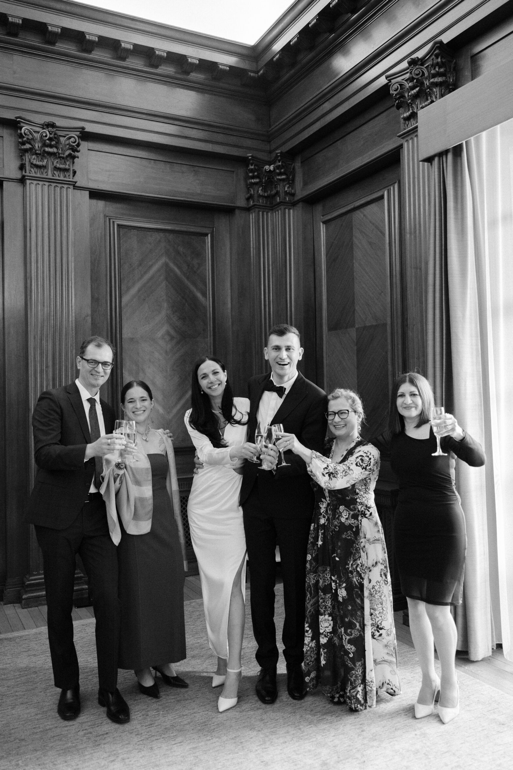Guests cheers and raise a glass of champagne at Old Marylebone Town Hall Wedding