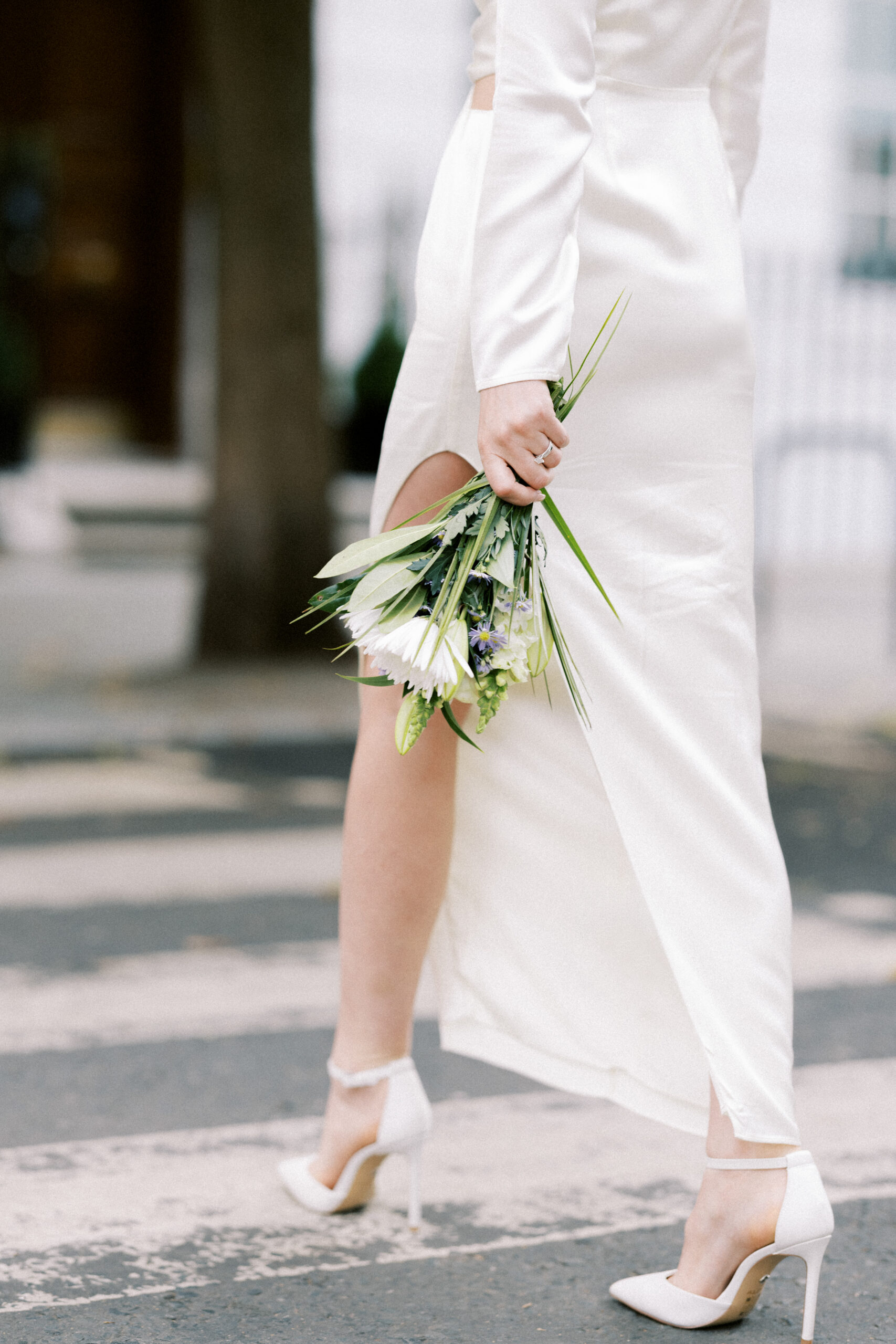 Bride walks across the street after just getting married at Marylebone Town Hall