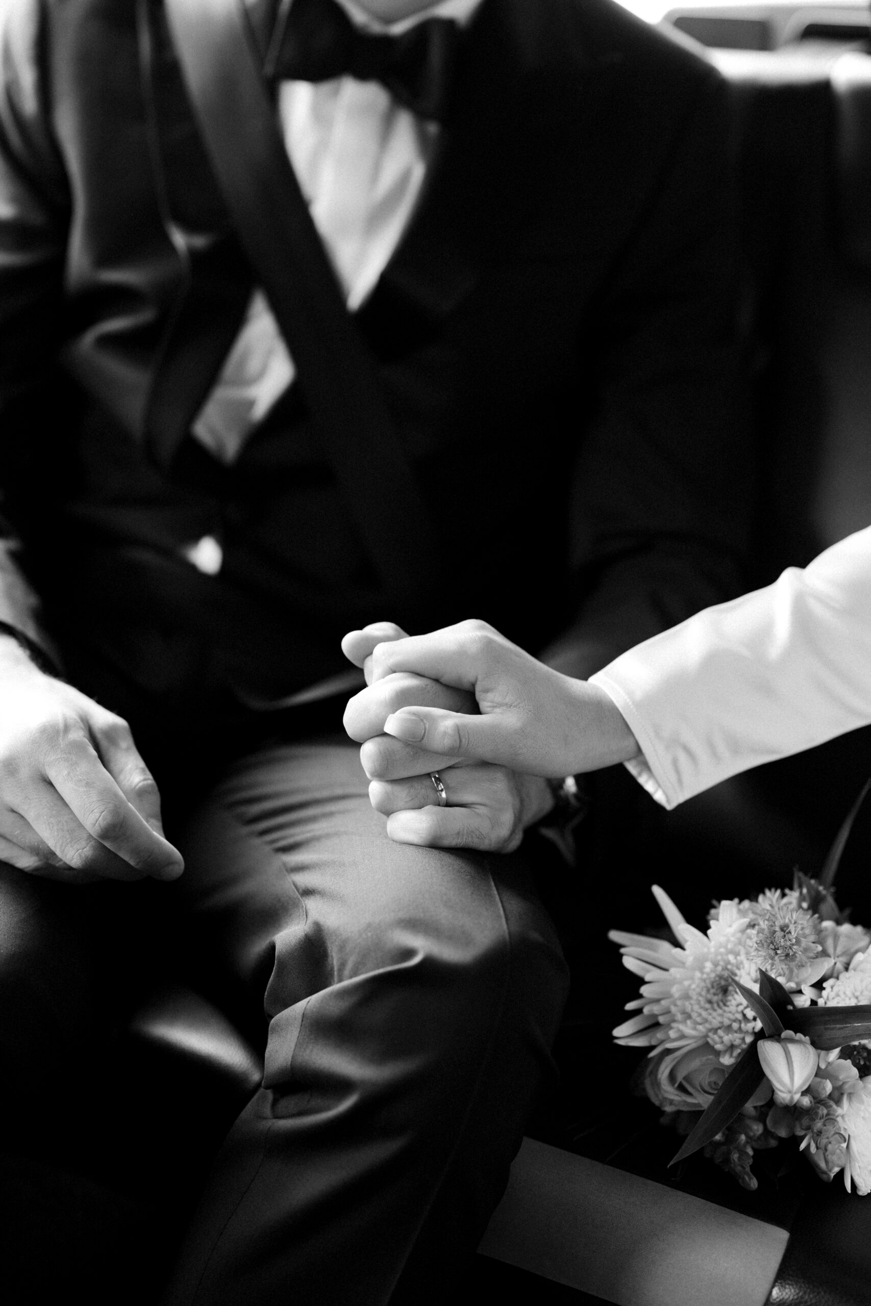 Detail shot of couple holding hands in a London Black cab after their Old Marylebone Town Hall wedding.