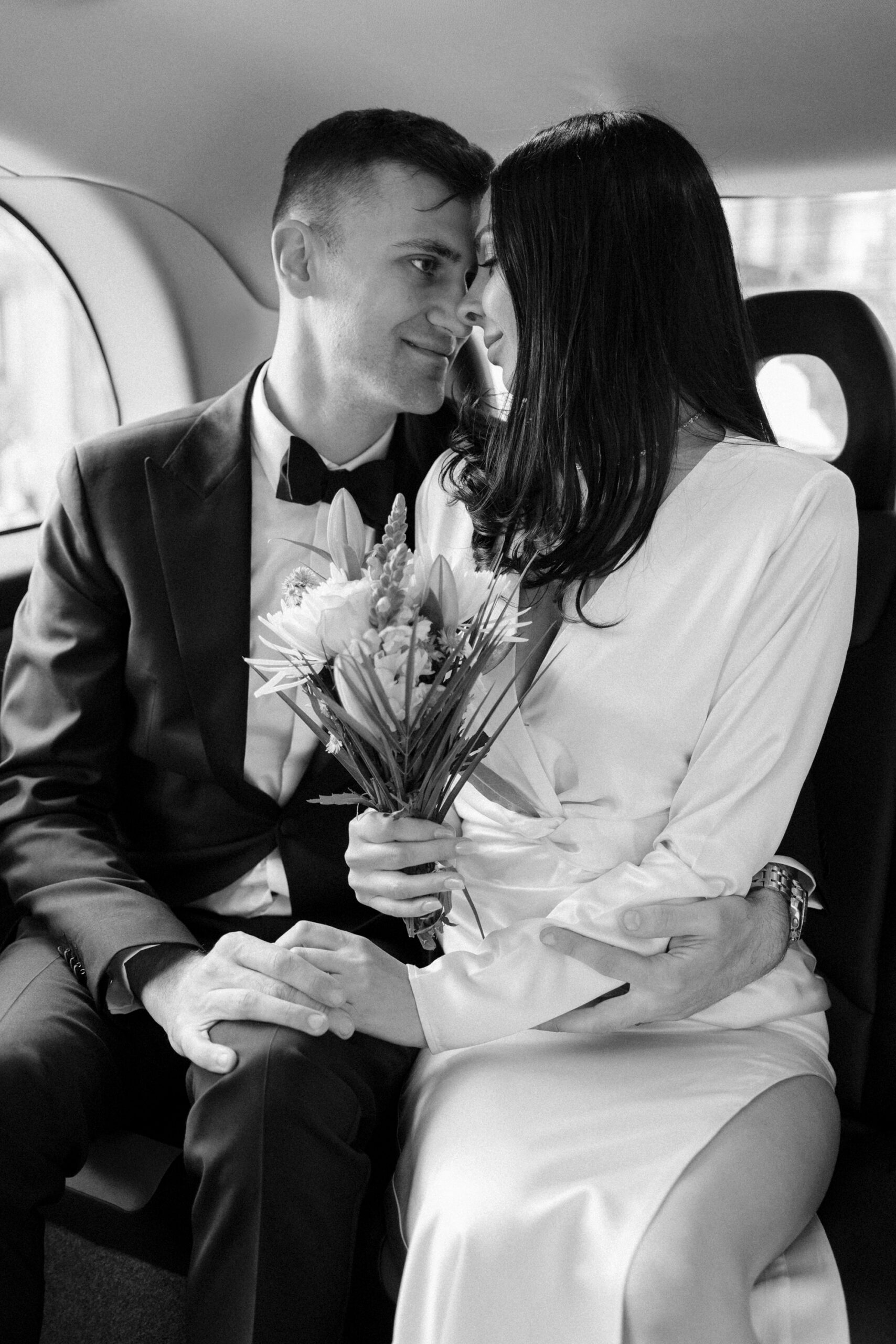Bride & Groom ride in a London black cab after their civil ceremony at Old Marylebone Town Hall in London