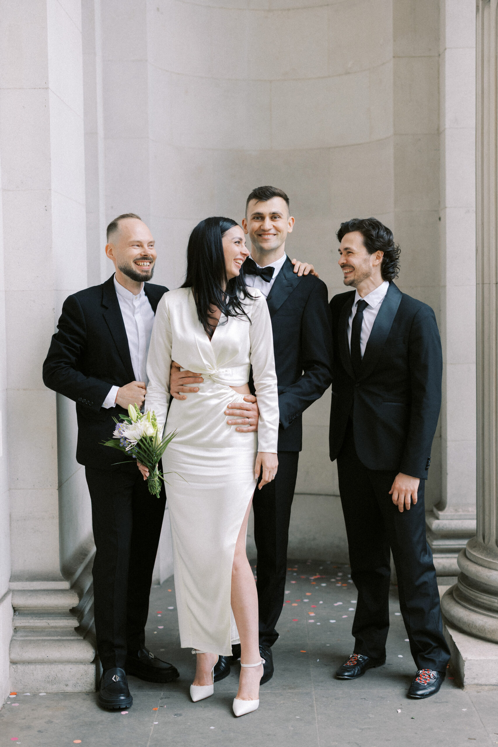 Guests laugh at Old Marylebone Town Hall wedding on the steps